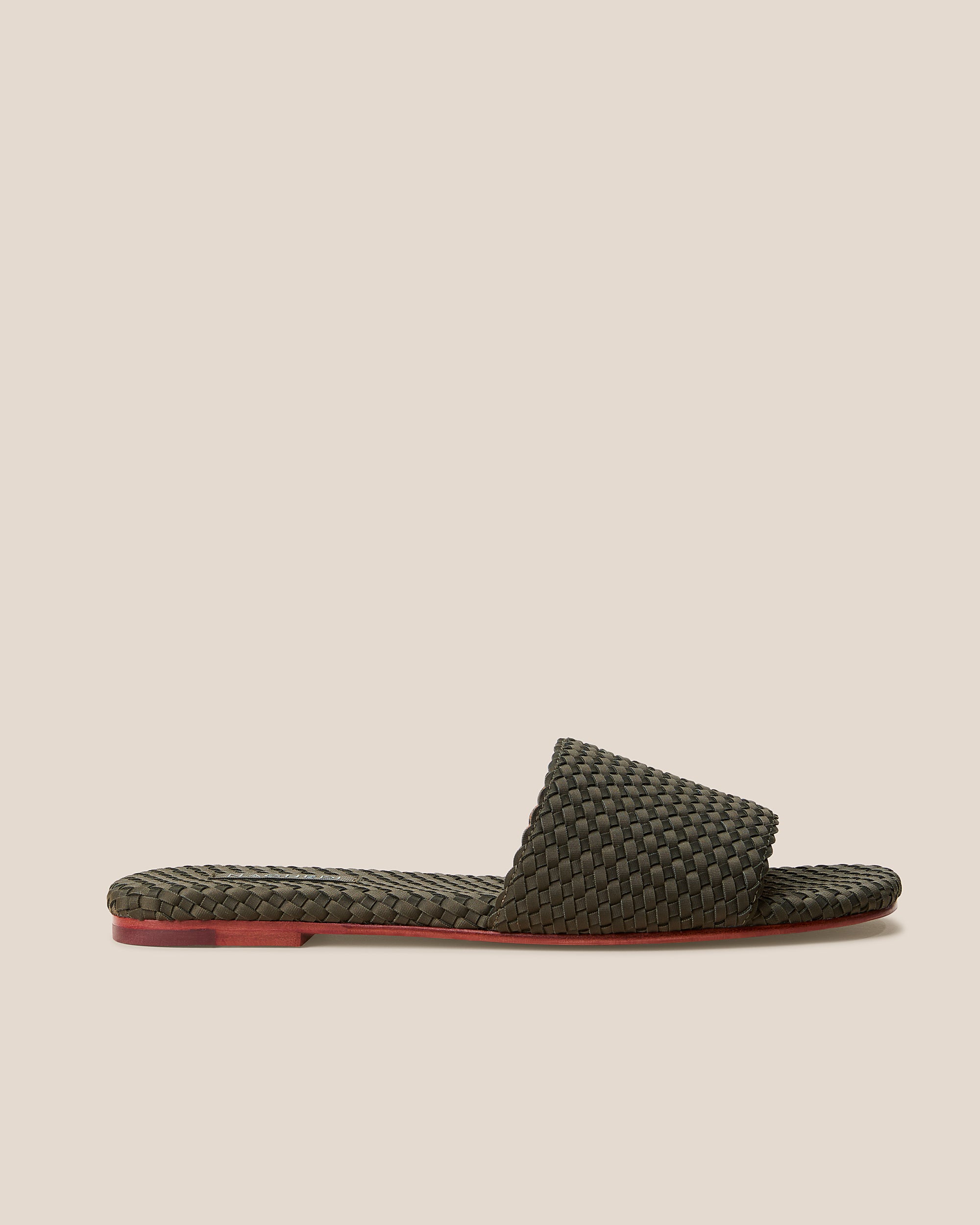 Side view of The St. Barths Slide in Olive, an olive green tone, featuring an open toe and square silhouette.