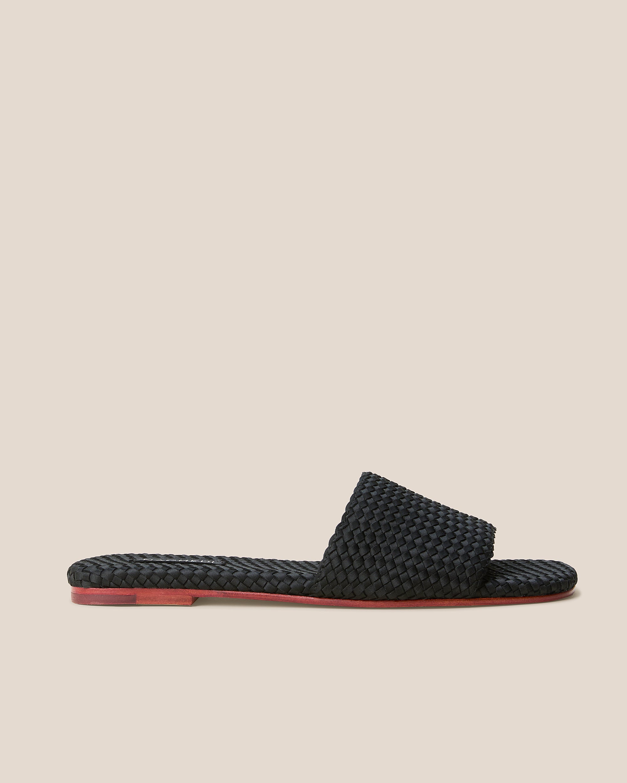 Side view of The St. Barths Slide in Onyx, a true black tone, featuring an open toe and square silhouette.