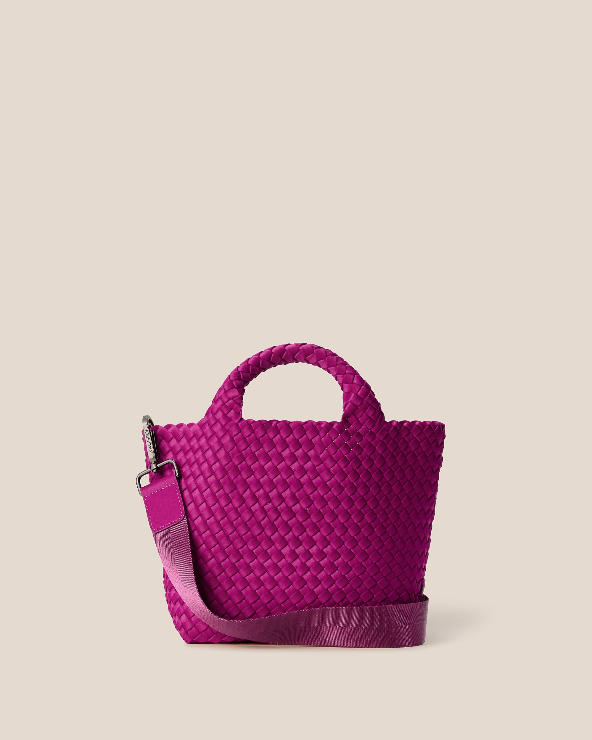 St. Barths Tote in Rio, a fuchsia tone, in handwoven neoprene, featuring an open top, woven top handles, and detachable, adjustable nylon crossbody strap.
