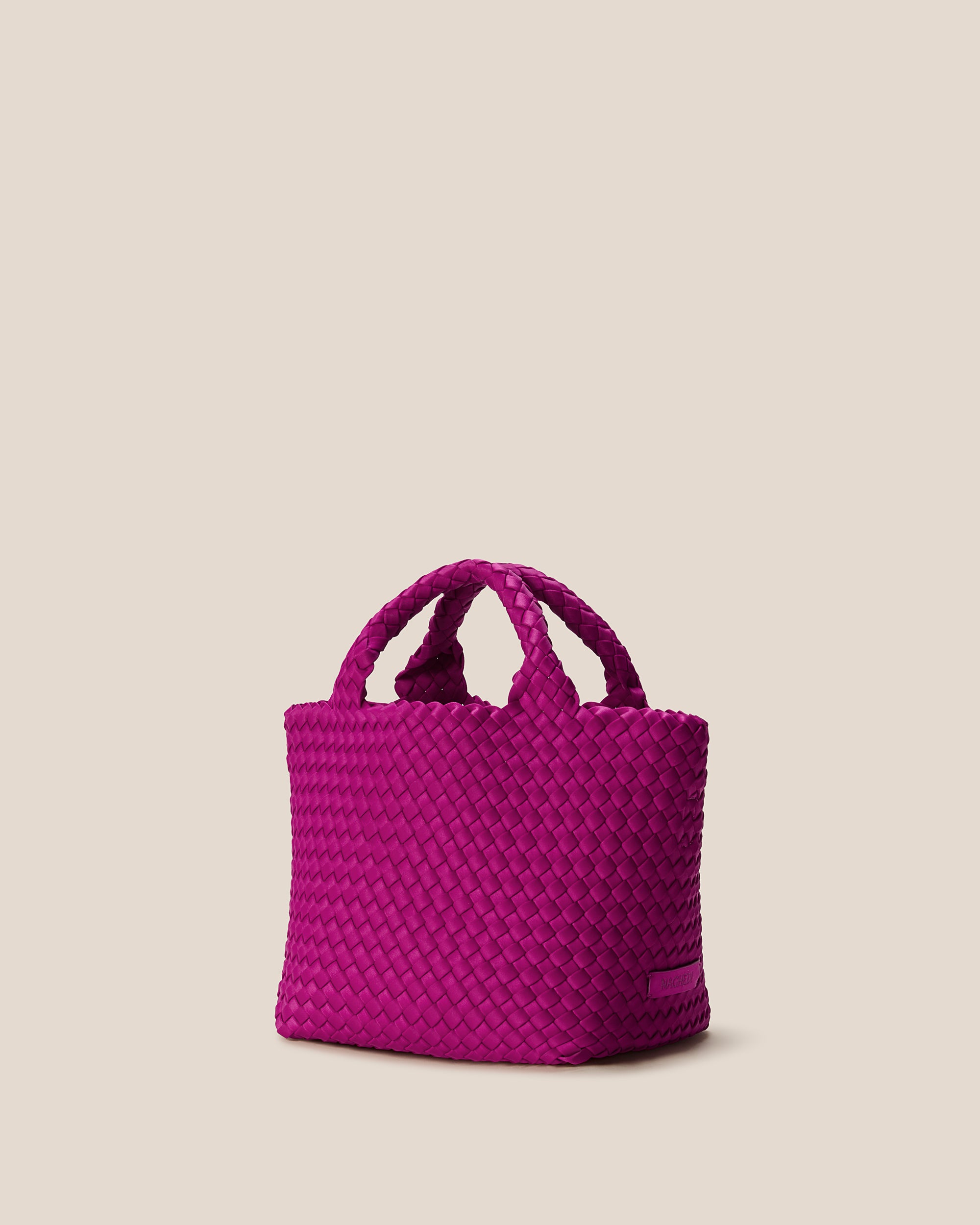 St. Barths Tote in Rio shown from a side angle, highlighting its handwoven neoprene construction and open top.