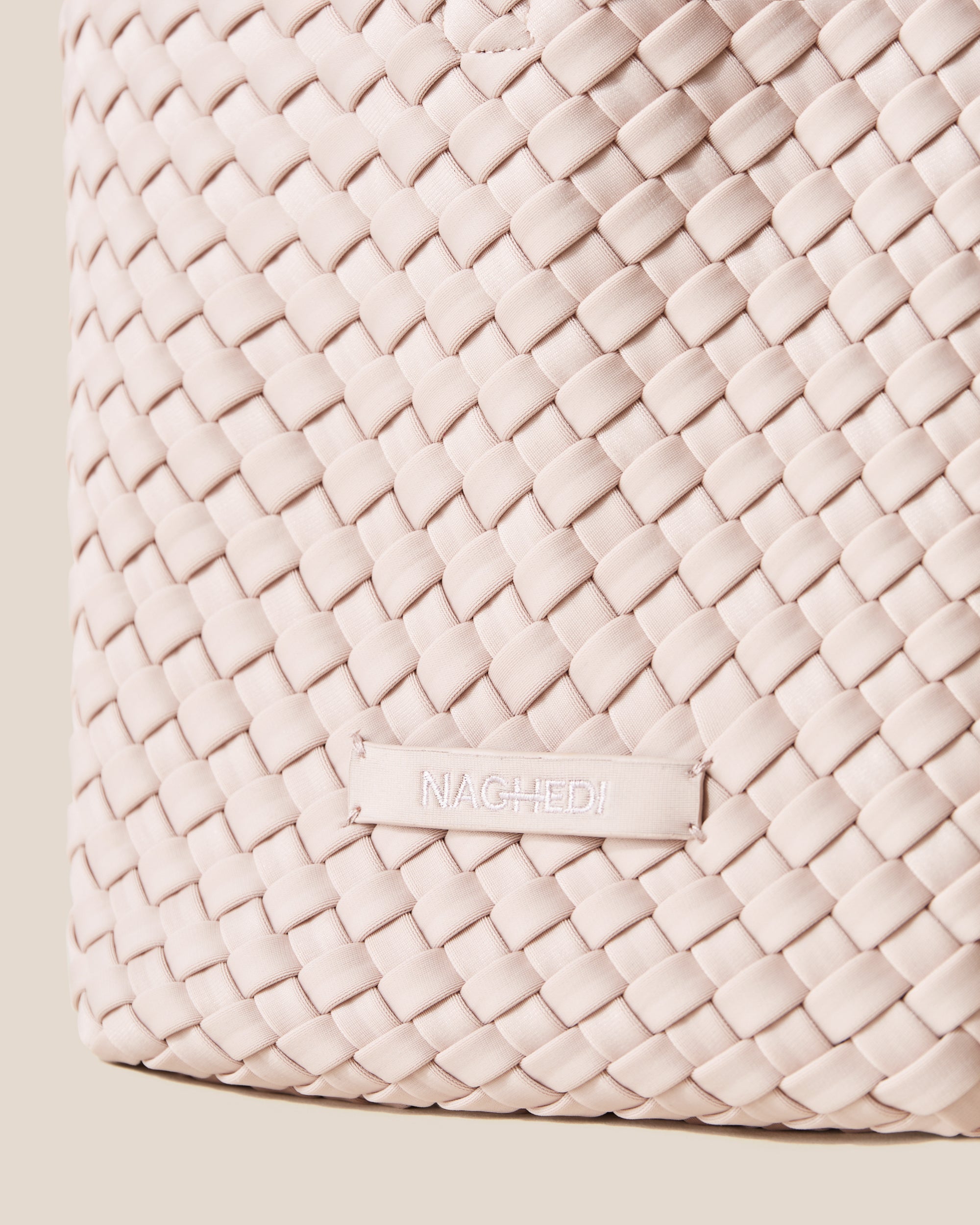 Close-up of stamped NAGHEDI logo on St. Barths Tote in Shell Pink.