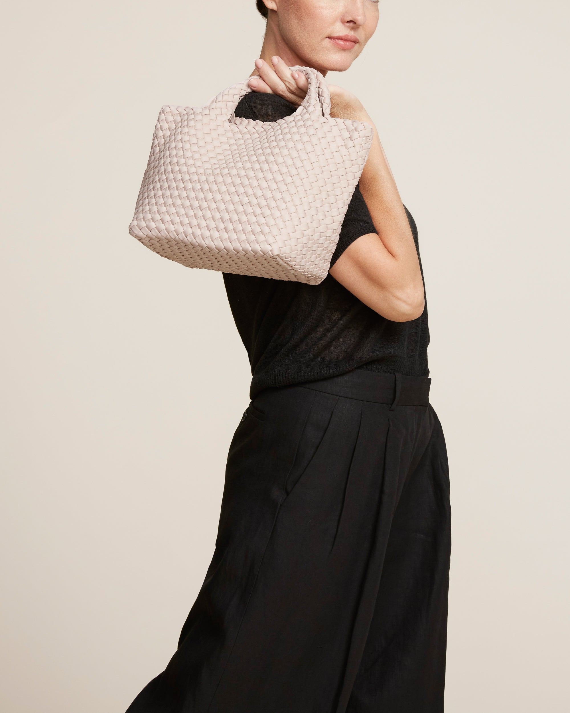 St. Barths Tote in Shell Pink shown on model to illustrate scale and soft silhouette.