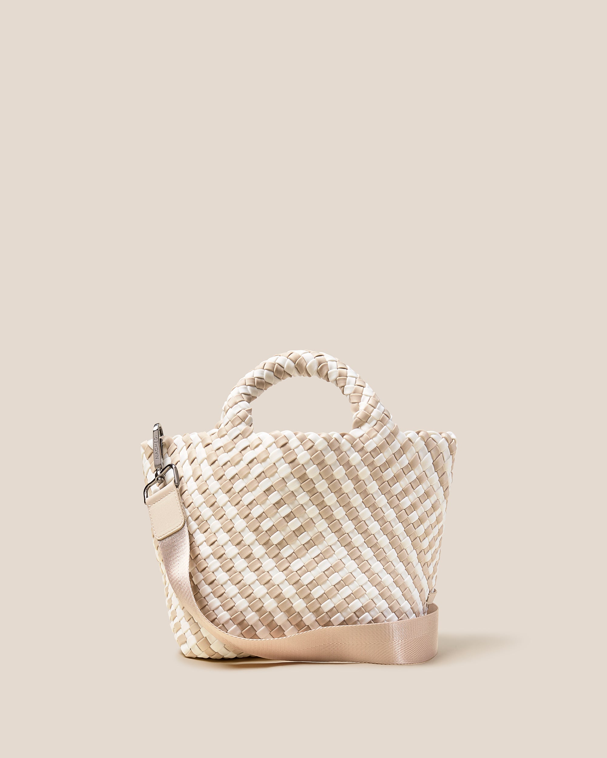 St. Barths Tote in Mykonos, a cream and ivory tone, in handwoven neoprene, featuring an open top, woven top handles, and detachable, adjustable nylon crossbody strap.