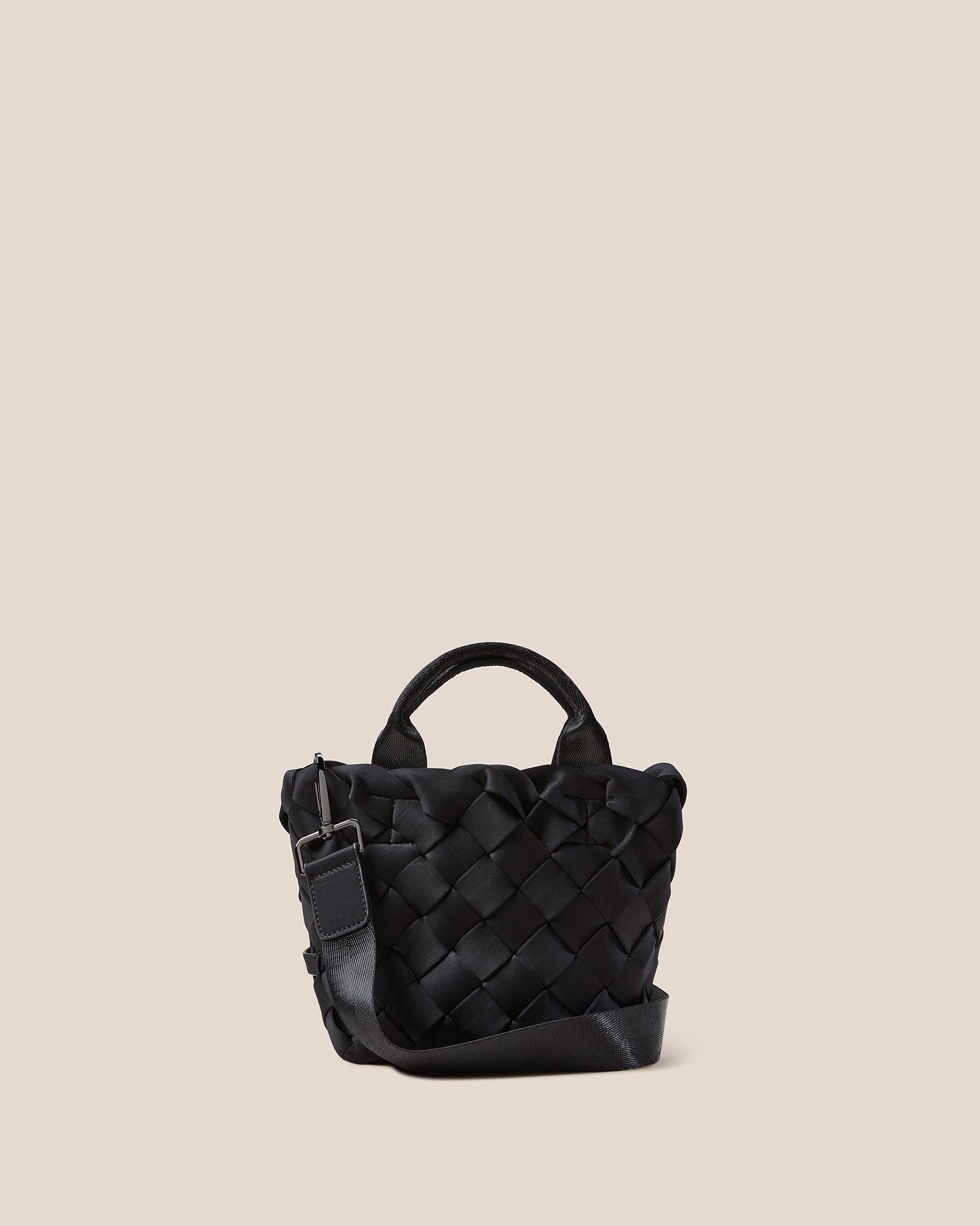 Tangier Tote in Onyx, a true black tone, in handwoven neoprene, featuring an open top, sleek nylon webbing handles, and detachable, adjustable nylon crossbody strap.
