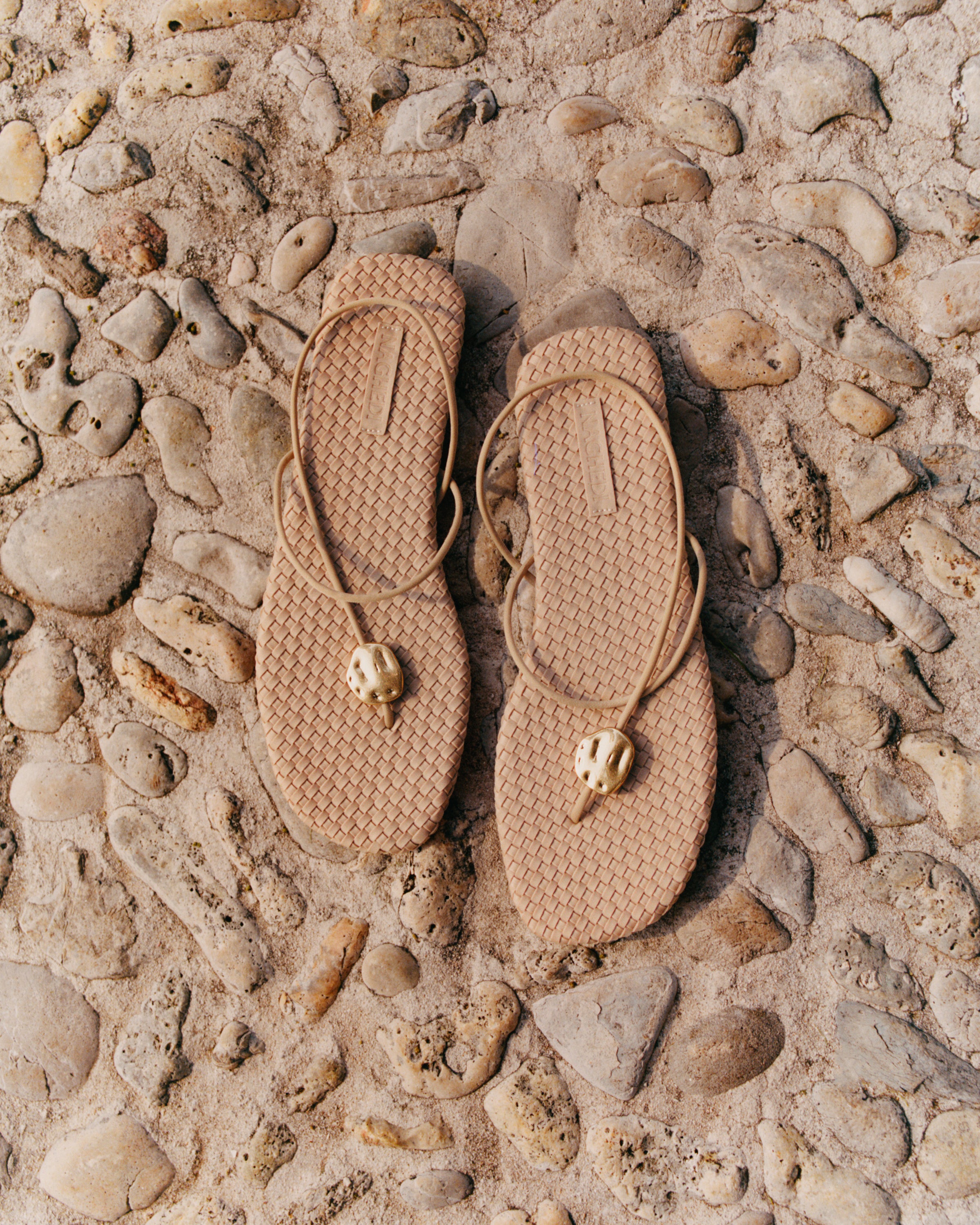 Top view of pair of The Gaia Sandal in Camel showing the handwoven neoprene insole.