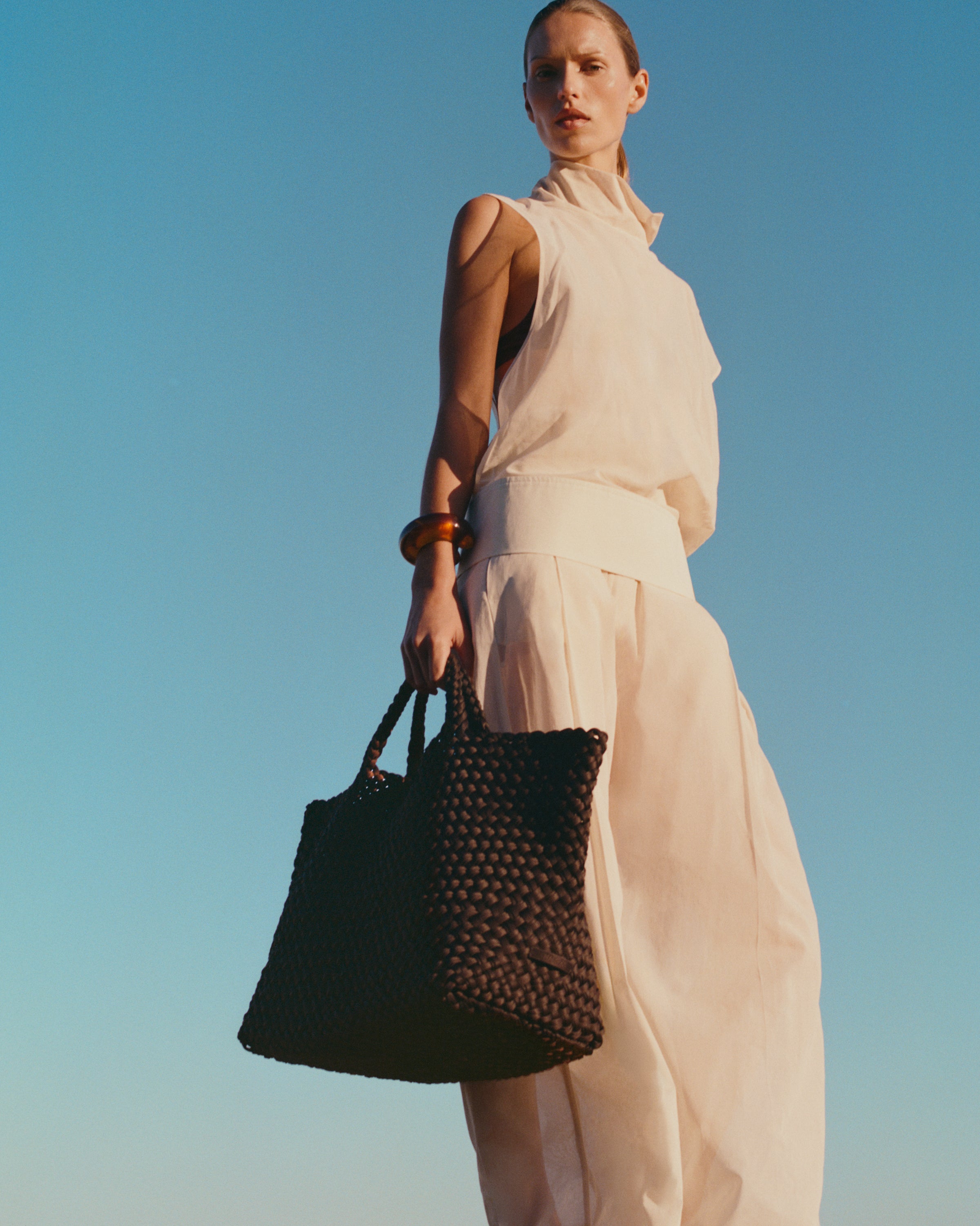St. Barths Tote in Chocolate shown on model to illustrate scale and soft silhouette.