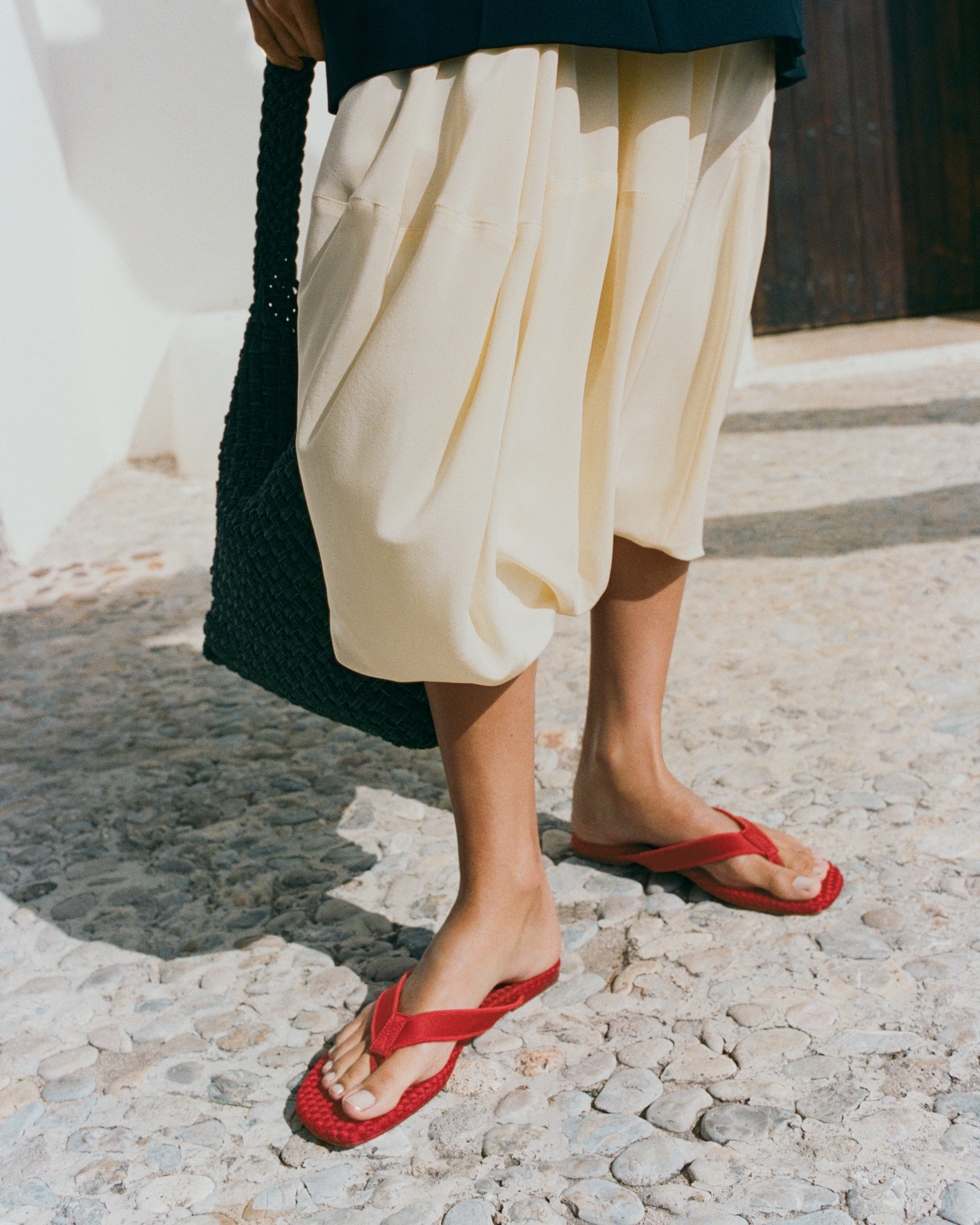 The Hydra Flip Flop in Rosso shown on model.