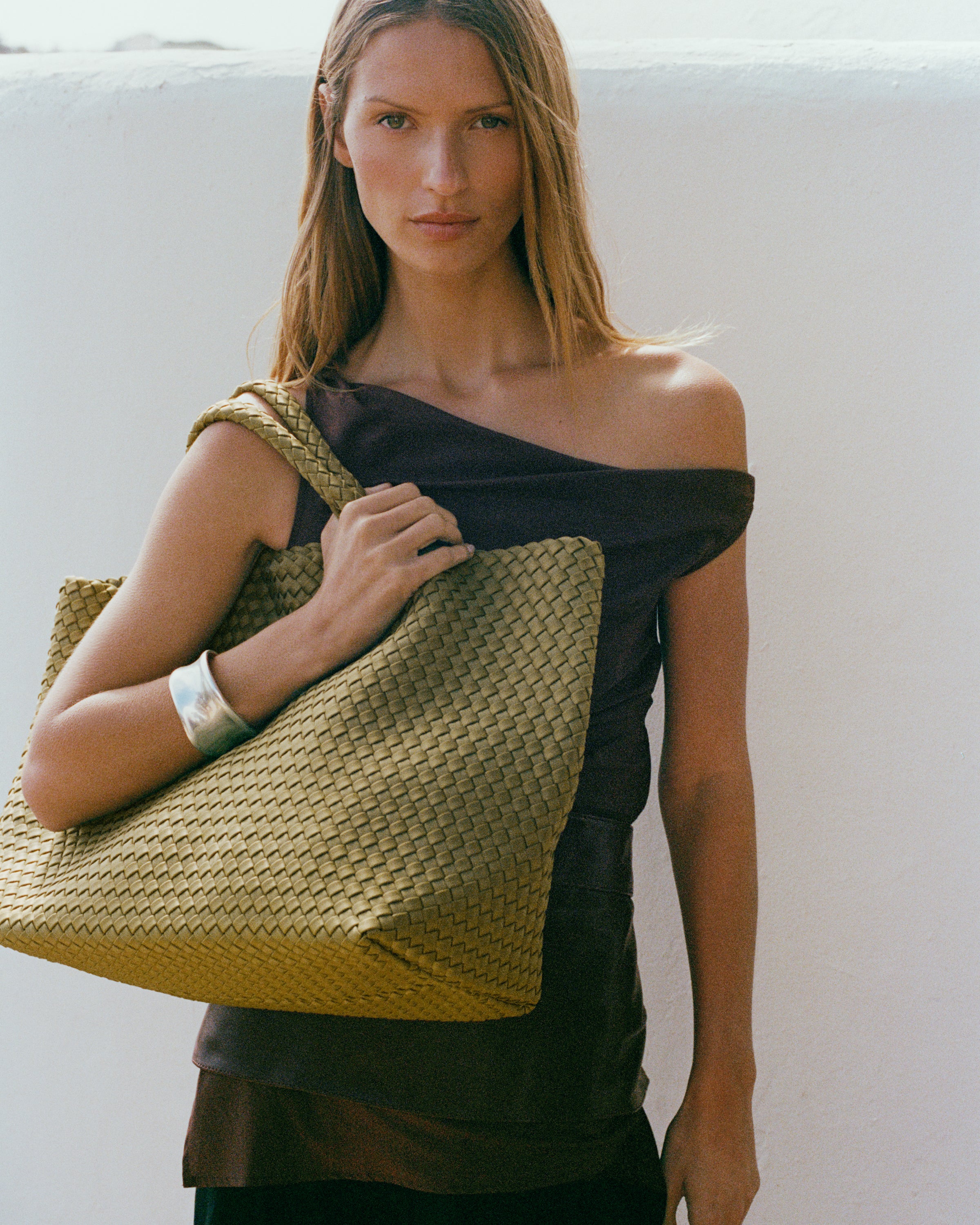 St. Barths Tote in Bottle Green shown on model to illustrate scale and soft silhouette.