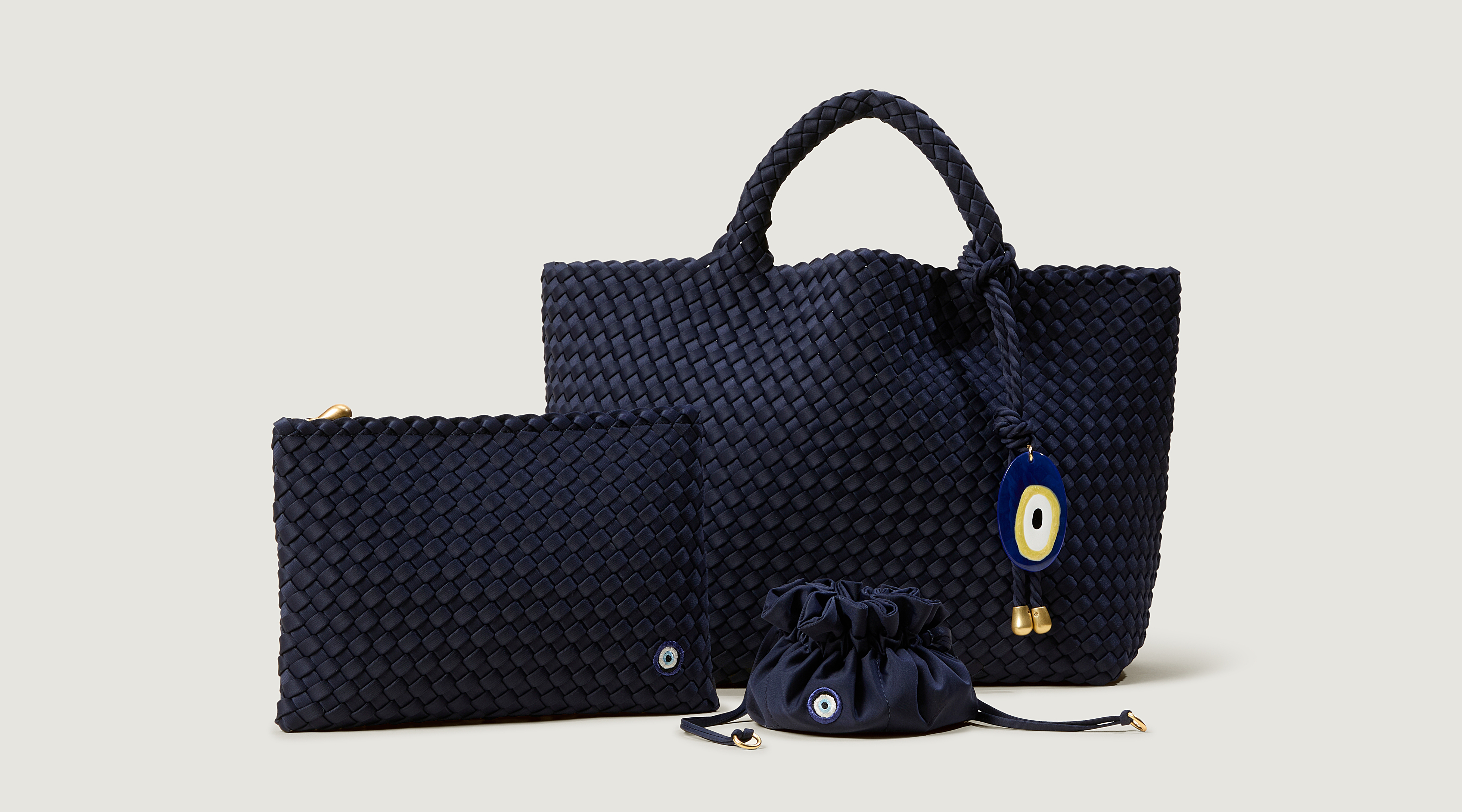 Set of navy blue woven handbags on a light gray background