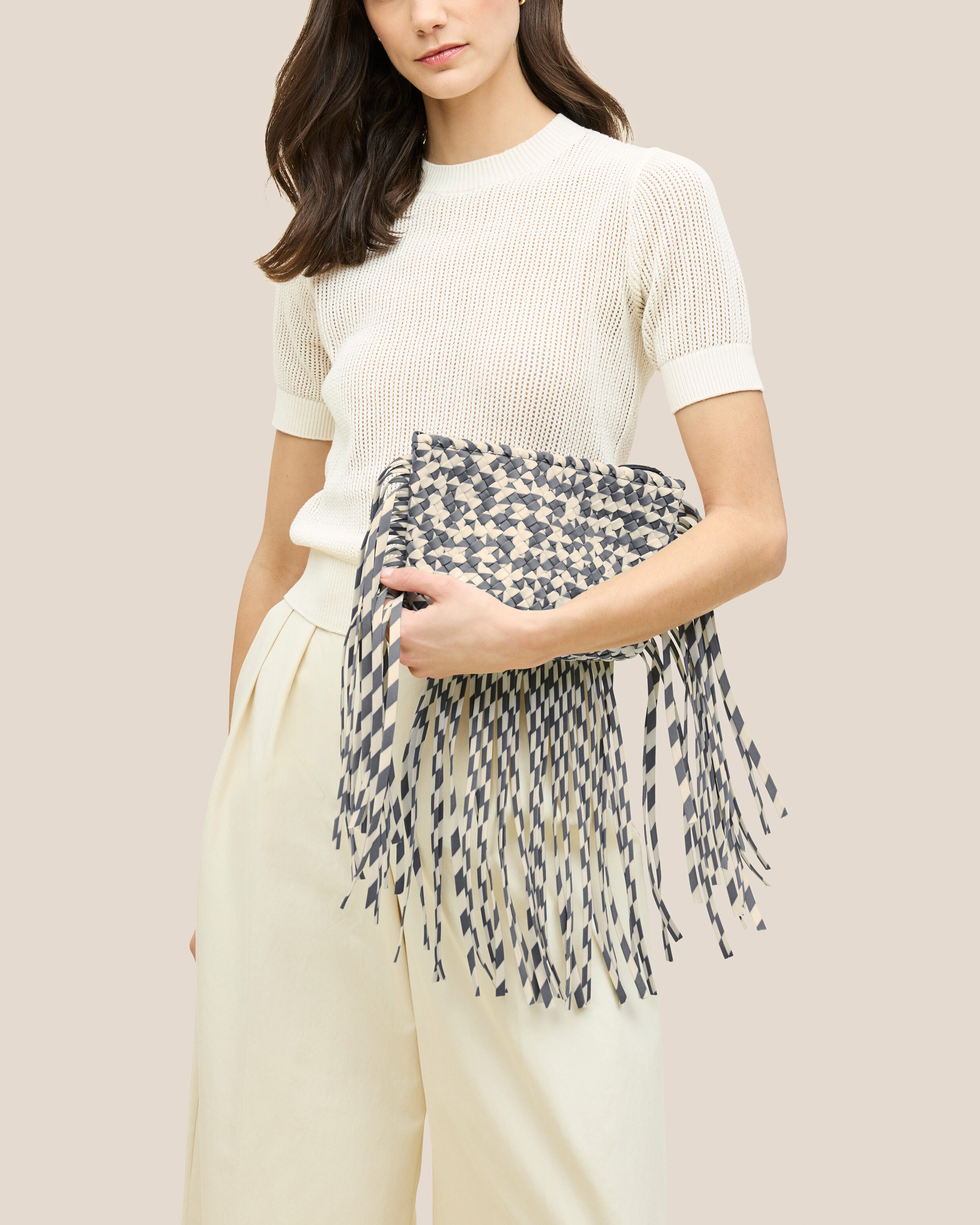 Antibes Clutch in Abalone shown on model to illustrate scale and soft silhouette.