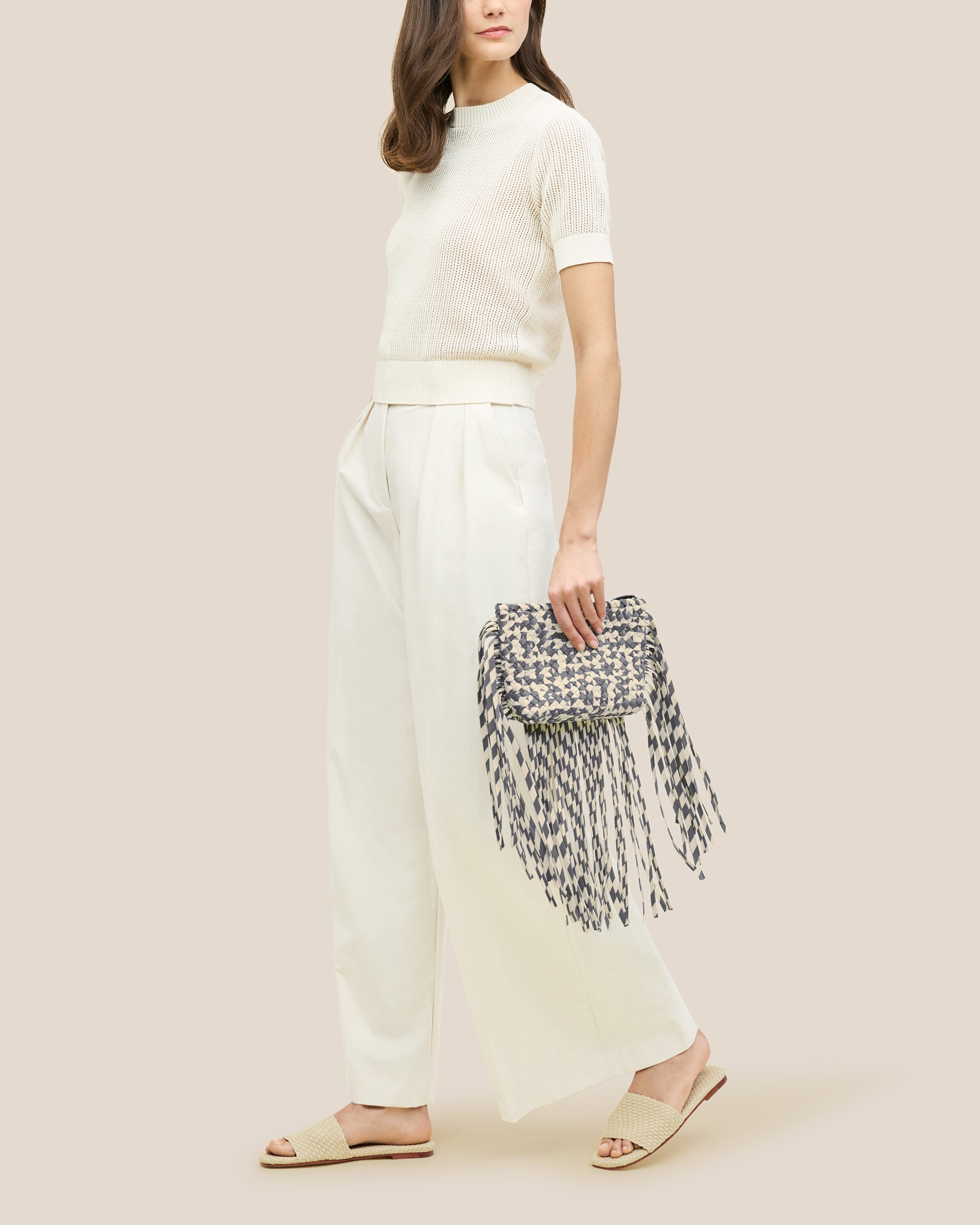 Antibes Clutch in Abalone shown on model to illustrate scale and soft silhouette.