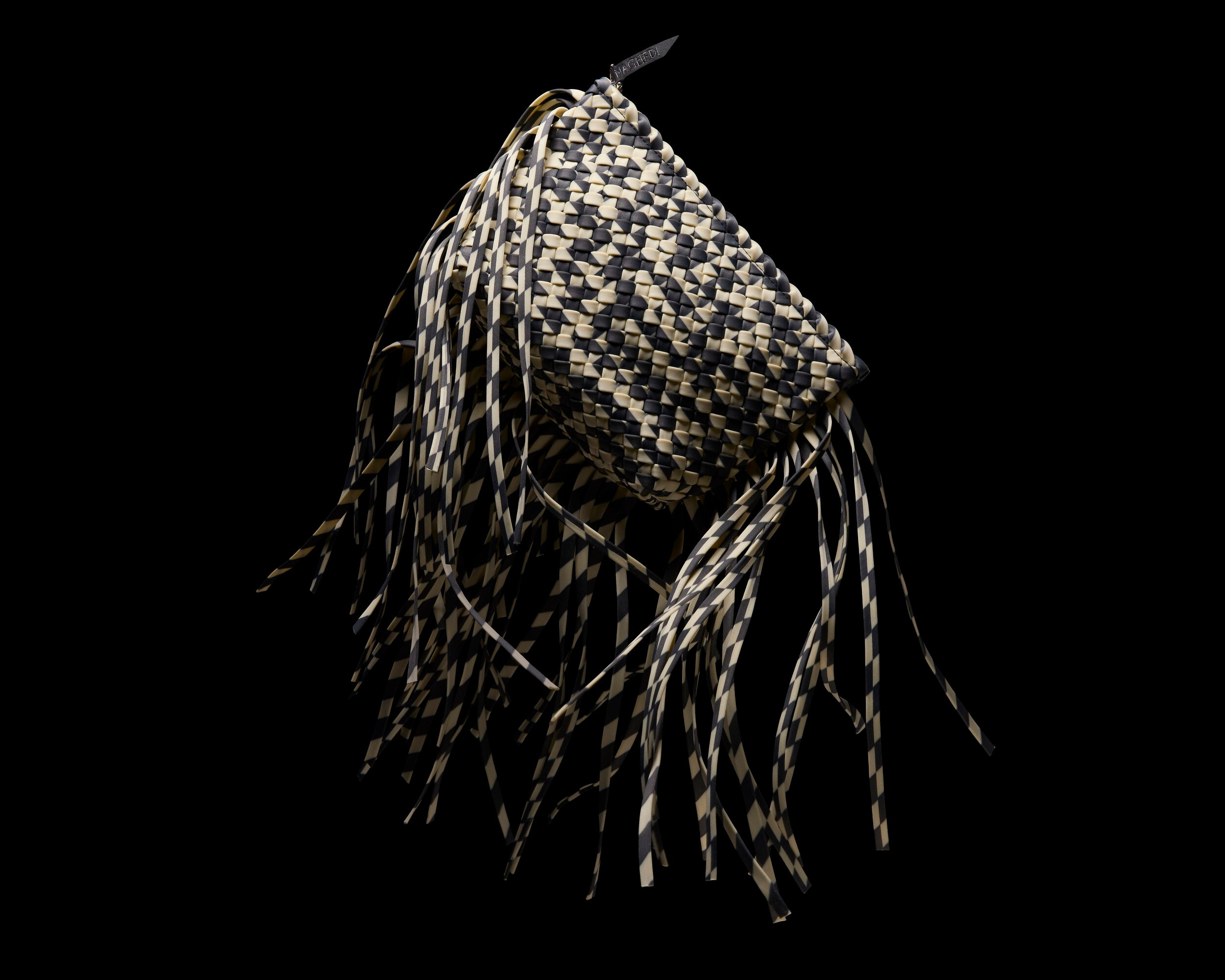 Antibes Clutch in Abalone shown from a side angle, highlighting its handwoven neoprene construction and zip closure with gunmental hardware.
