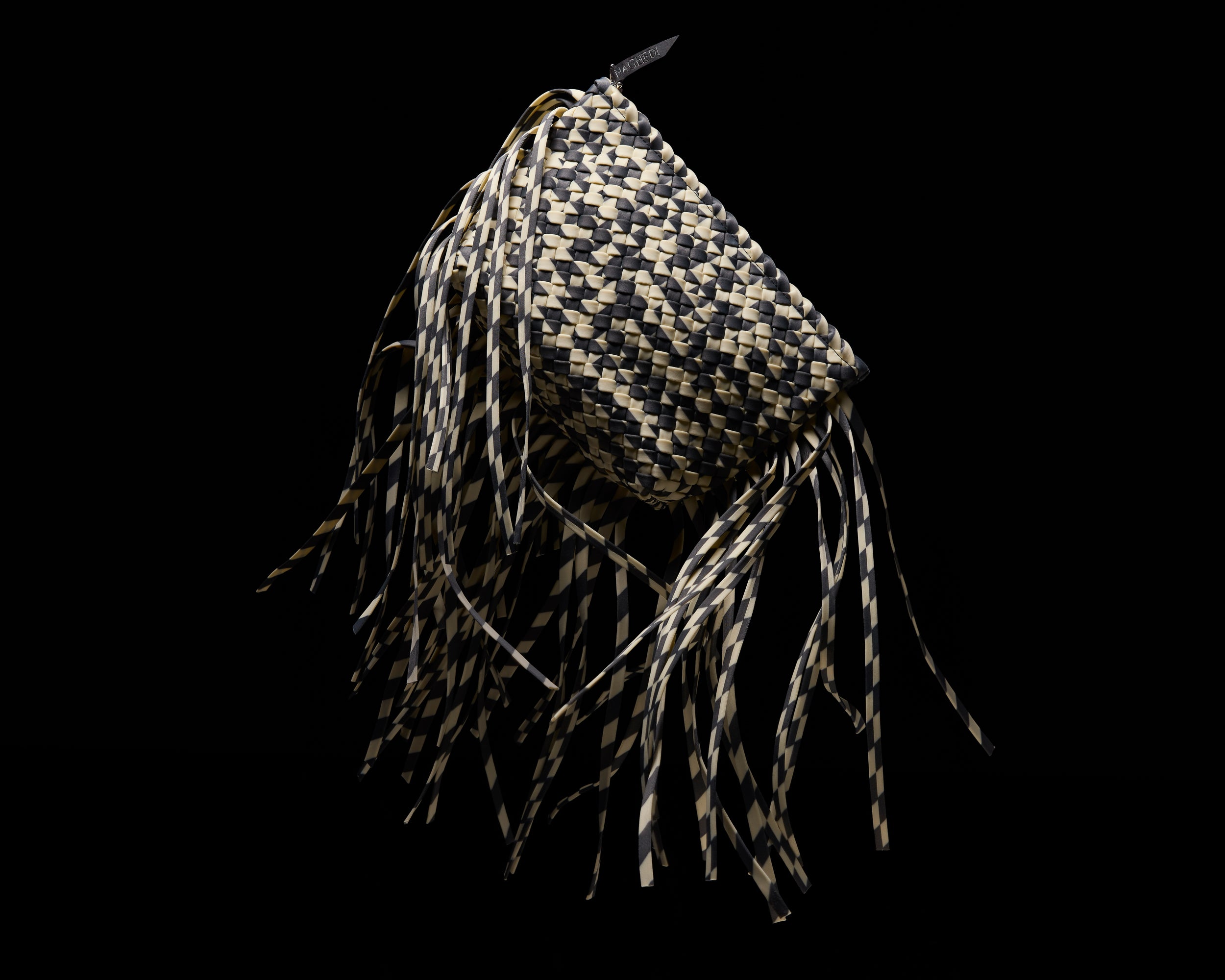 Antibes Prism Clutch Bag in Abalone shown from a side angle, highlighting its handwoven neoprene and zip closure with gunmental hardware.