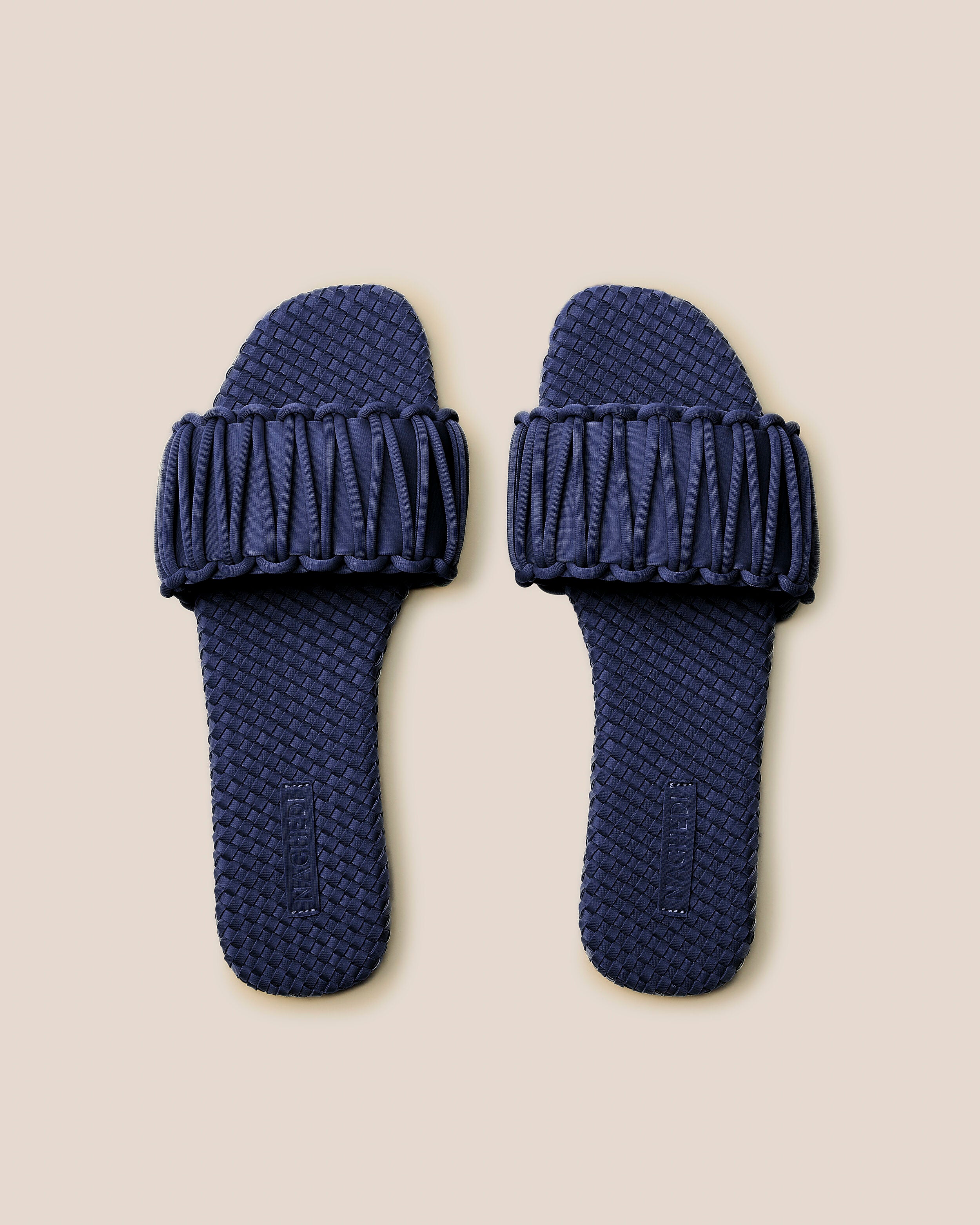 Top view of pair of The Athens Slide in Ink Blue showing the handwoven neoprene insole.