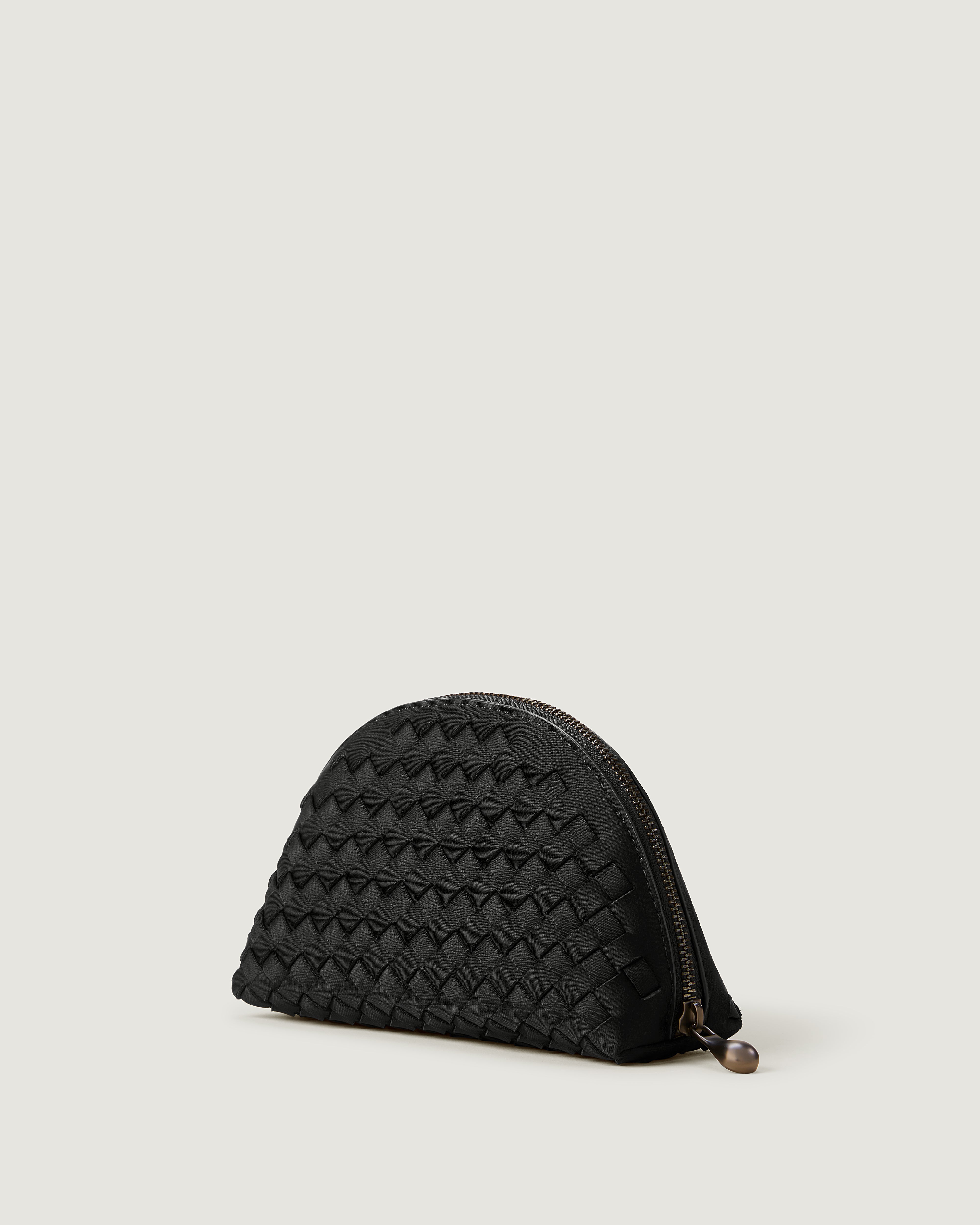 Atlas Cosmetic Case in Onyx shown from a side angle, highlighting its handwoven neoprene construction and wrap-around zip closure.