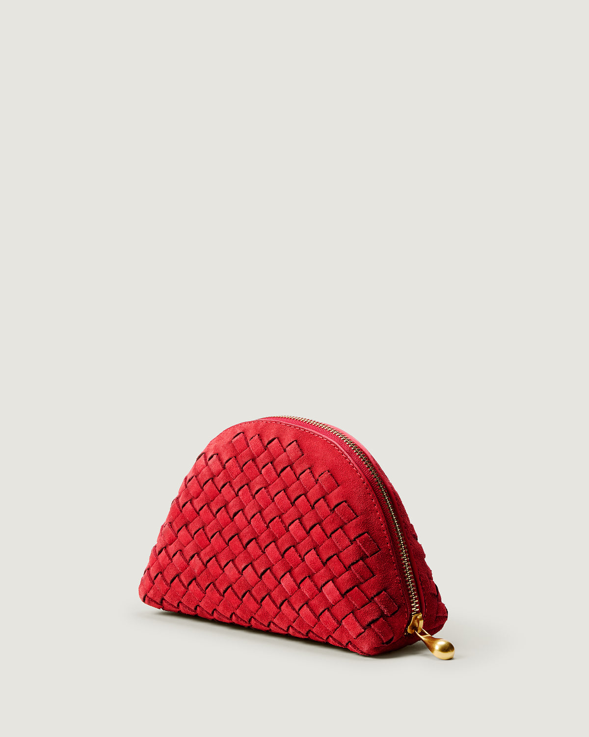 Atlas Cosmetic Case in Cerise shown from a side angle, highlighting its handwoven suede construction and wrap-around zip closure.