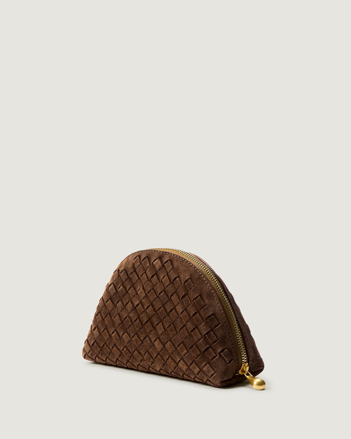 Atlas Cosmetic Case in Teak shown from a side angle, highlighting its handwoven suede construction and wrap-around zip closure.