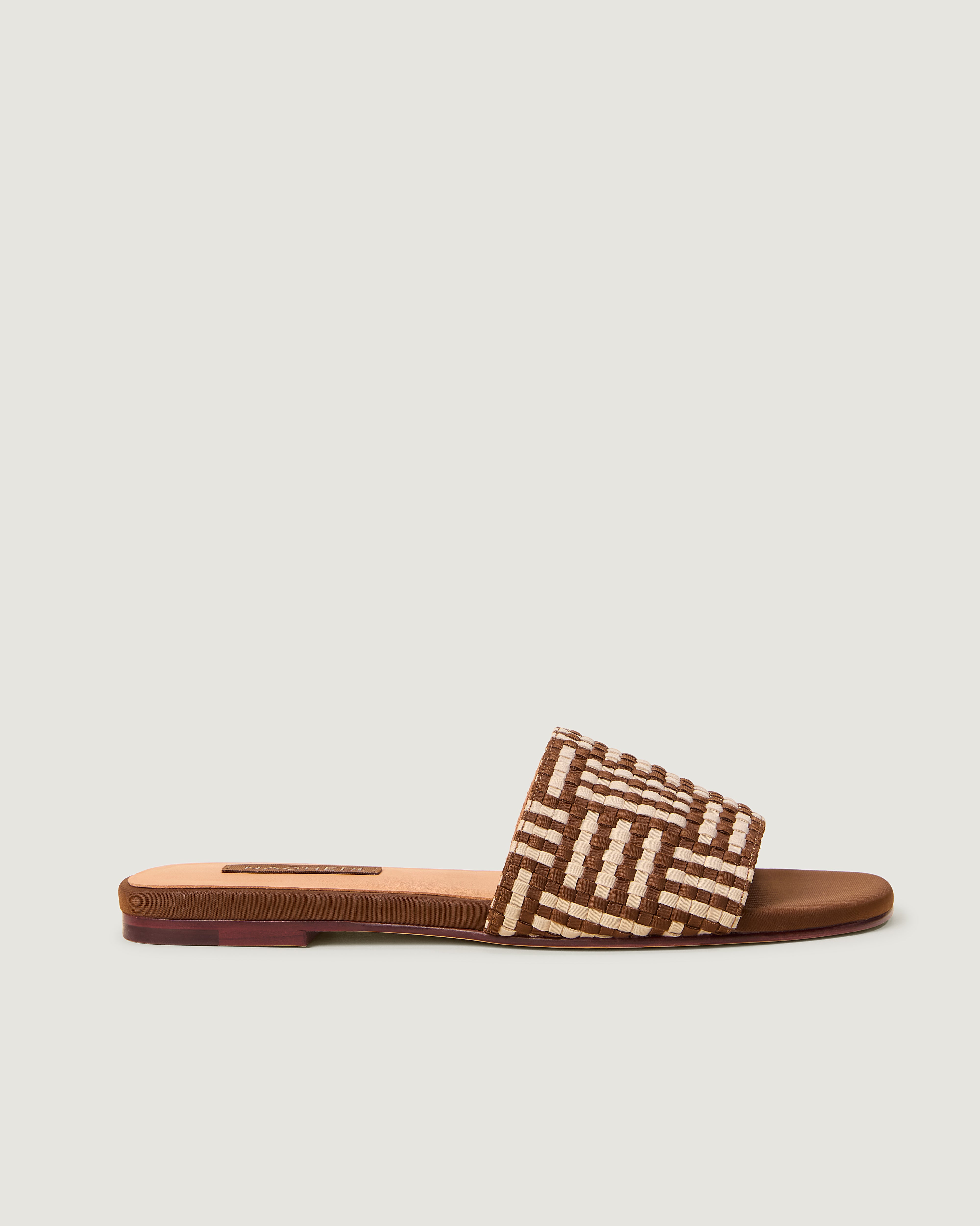 Side view of The Cairo Slide in Almond, a saddle brown and cream tone, featuring an open toe and square silhouette.