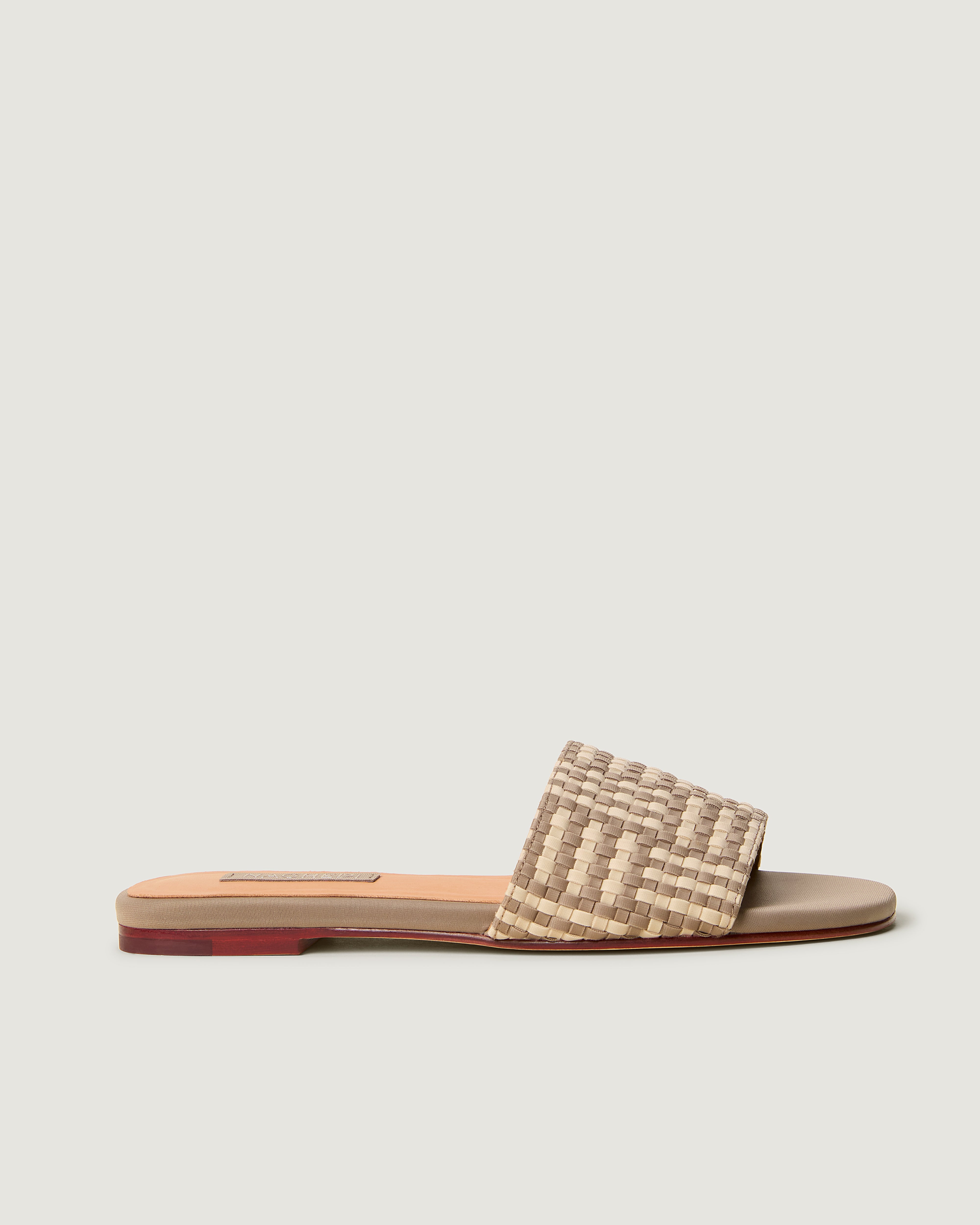 Side view of The Cairo Slide in Chalk, a taupe and cream tone, featuring an open toe and square silhouette.