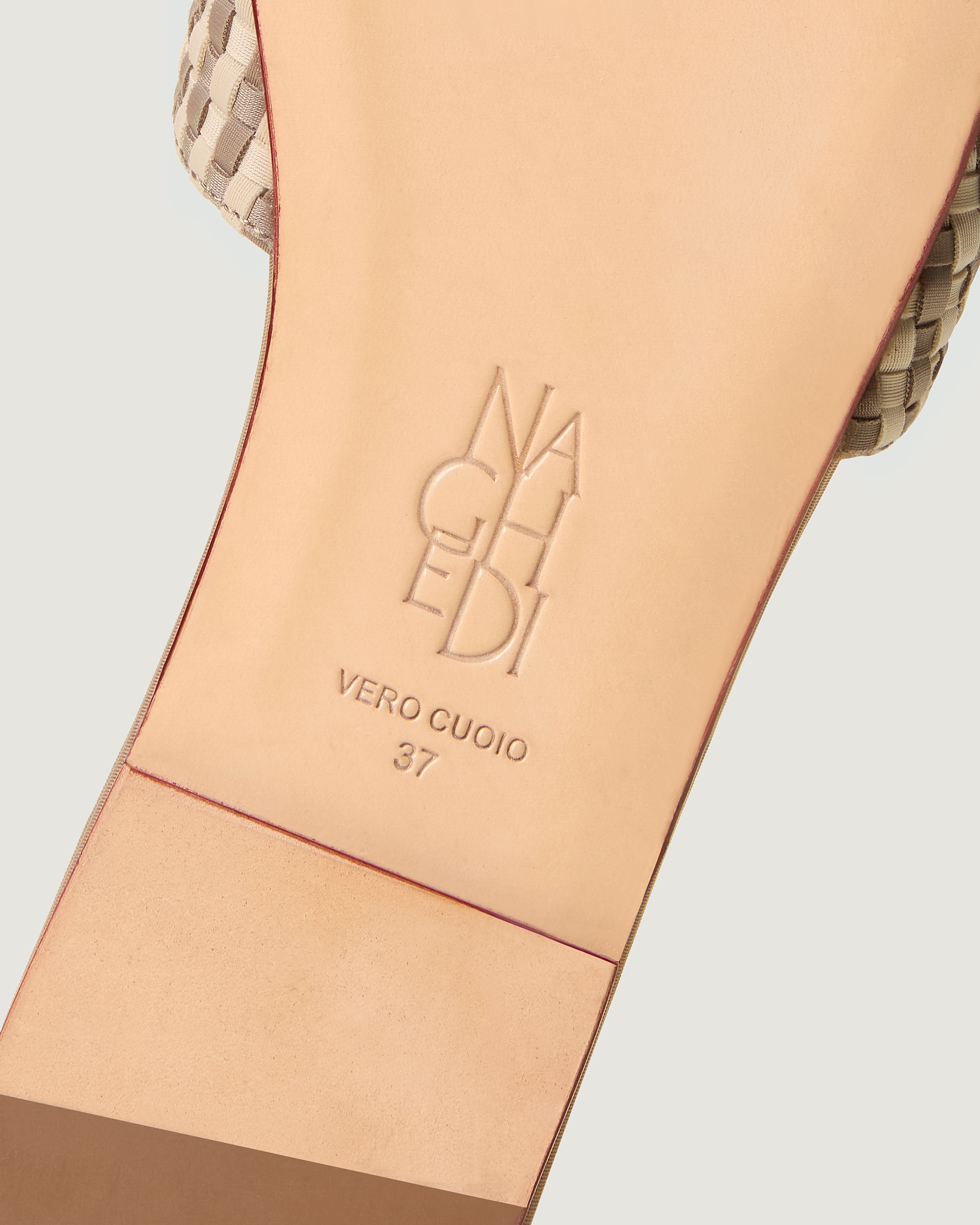 Shoe sole showing natural buffed leather sole, stamped NAGHEDI logo and size detail for The Cairo Slide in Chalk.
