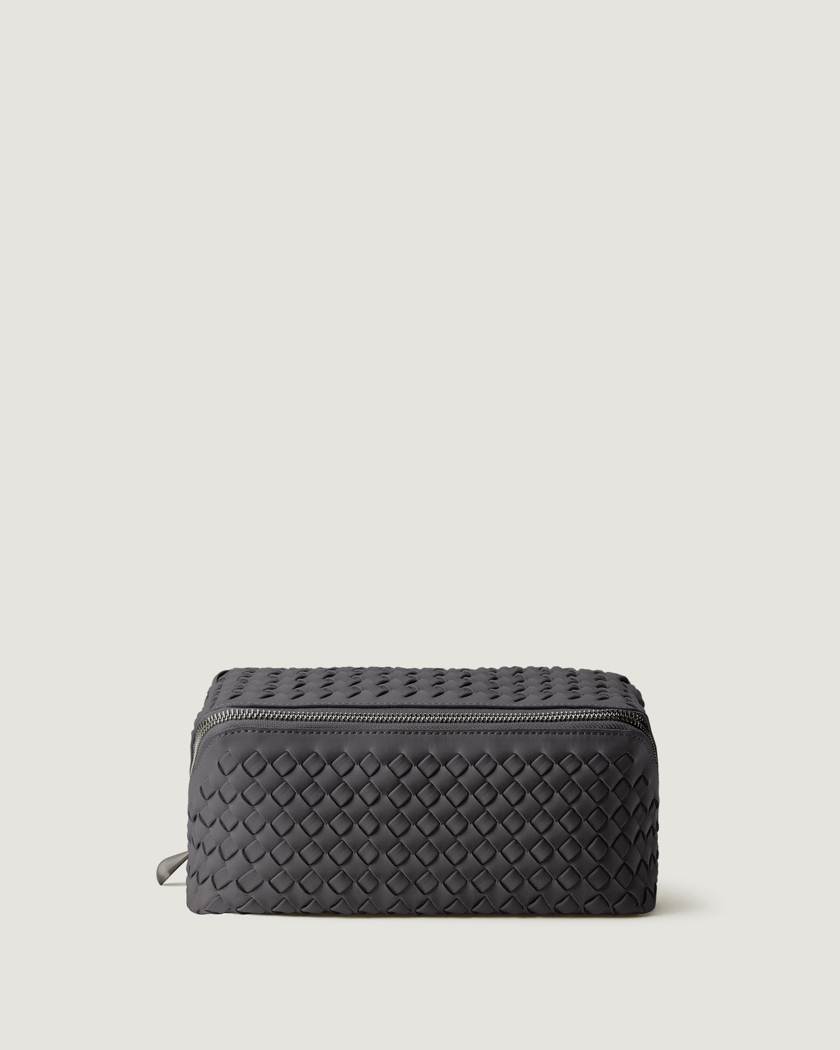 Caravan Cosmetic Case in Ash, a true gray tone, in handwoven neoprene, featuring a wrap-around zip closure.