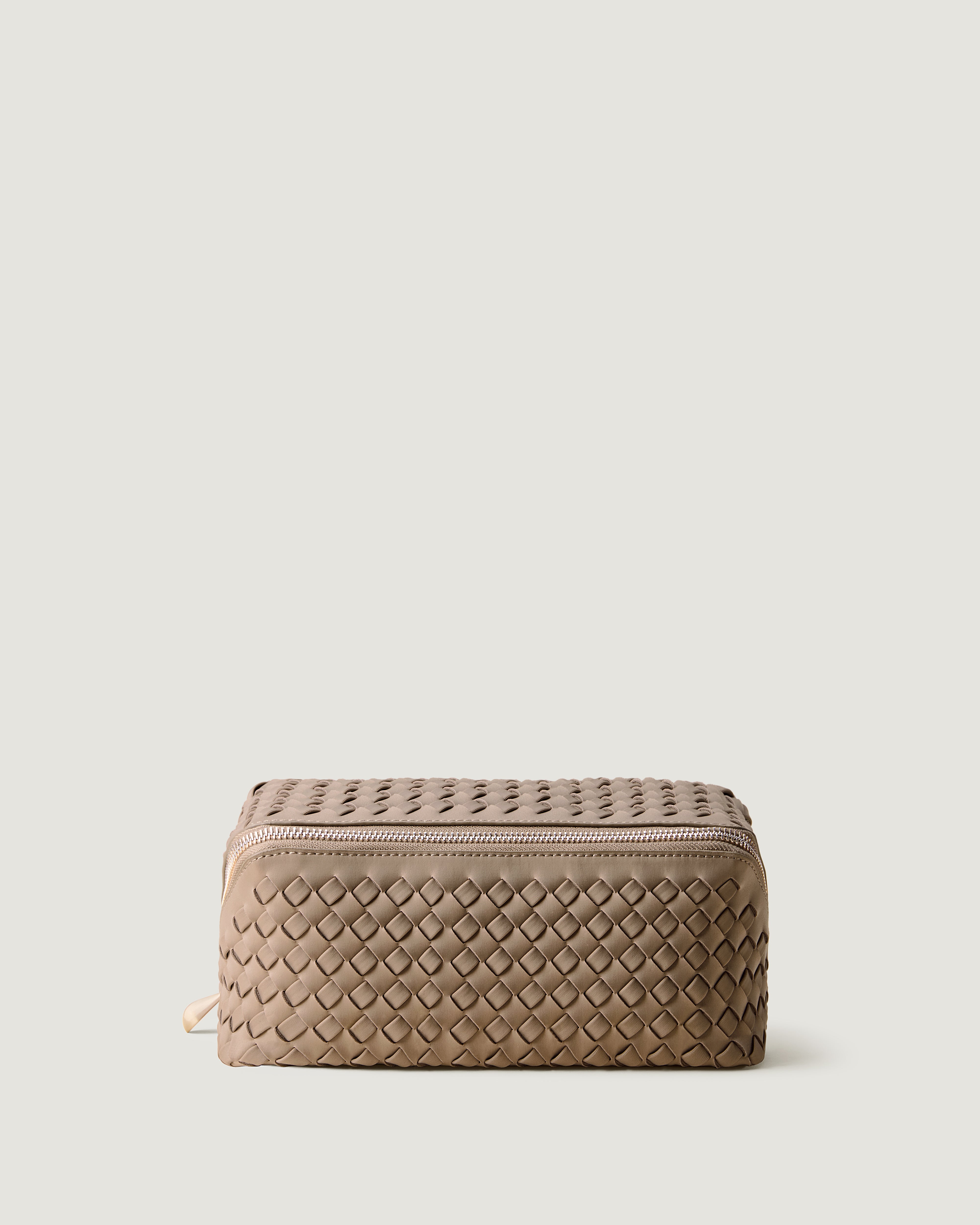 Caravan Cosmetic Case in Cashmere, a taupe tone, in handwoven neoprene, featuring a wrap-around zip closure.