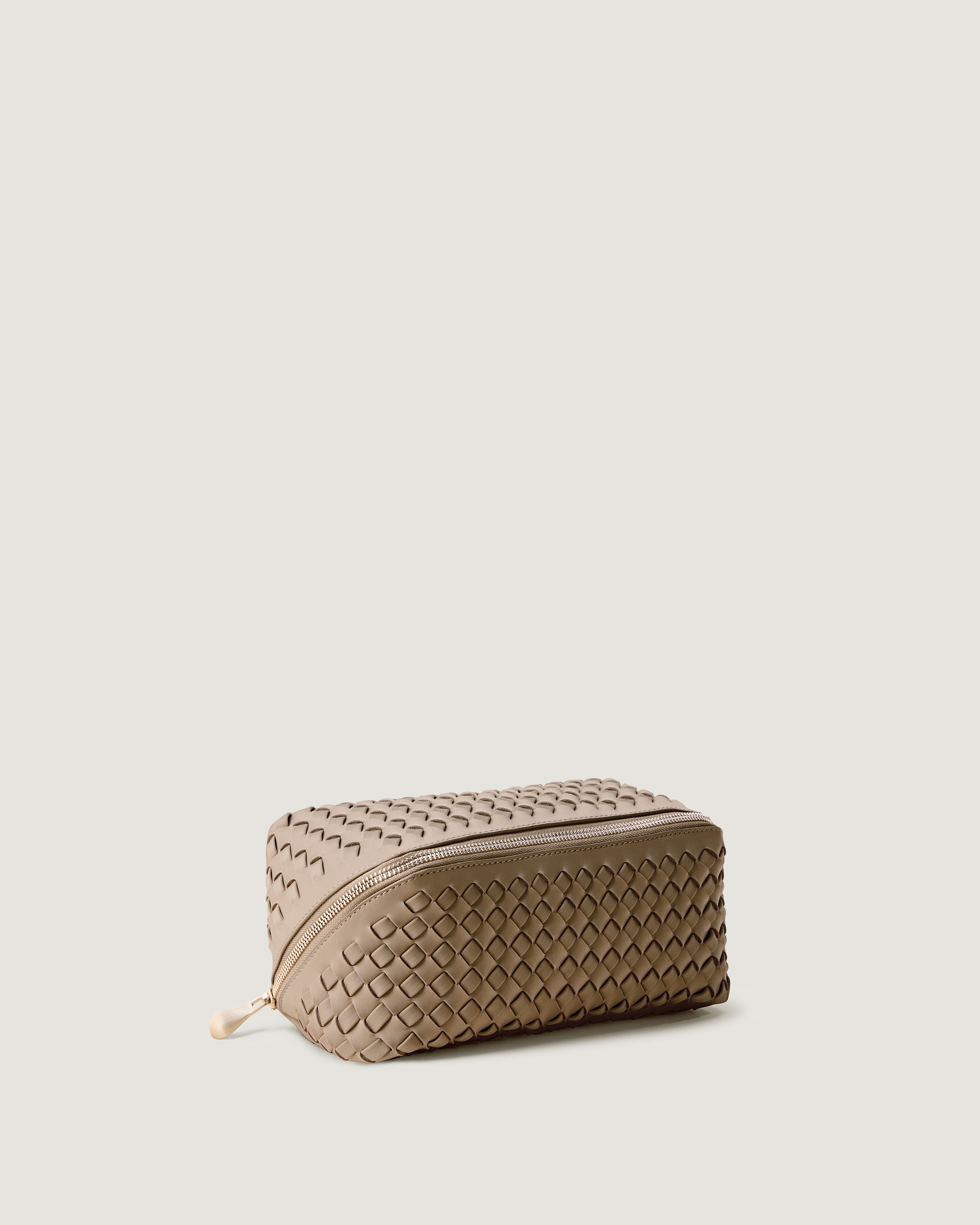 Caravan Cosmetic Case in Cashmere shown from a side angle, highlighting its handwoven neoprene construction and wrap-around zip closure.