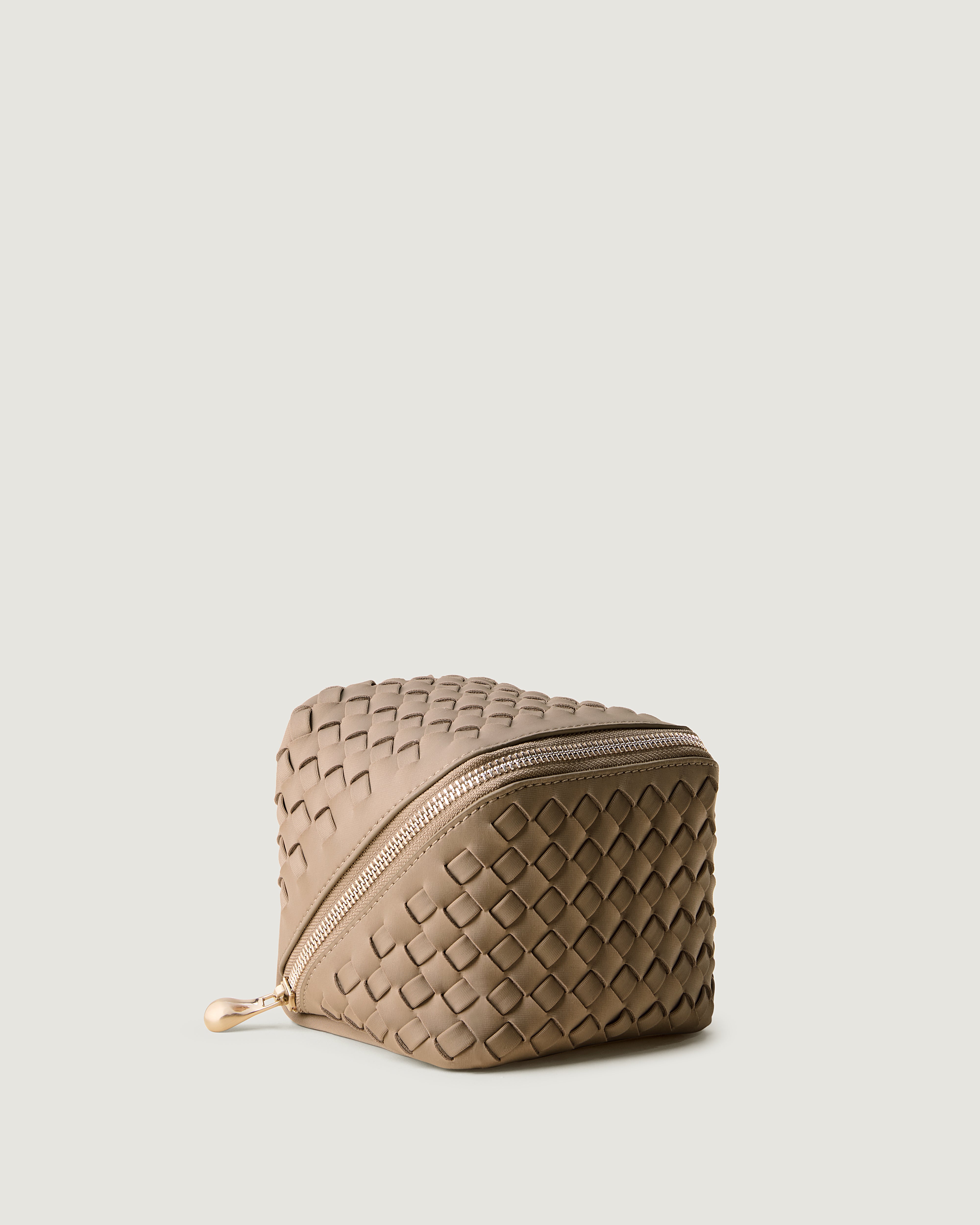Caravan Cosmetic Case in Cashmere shown from a side angle, highlighting its  and wrap-around zip closure.