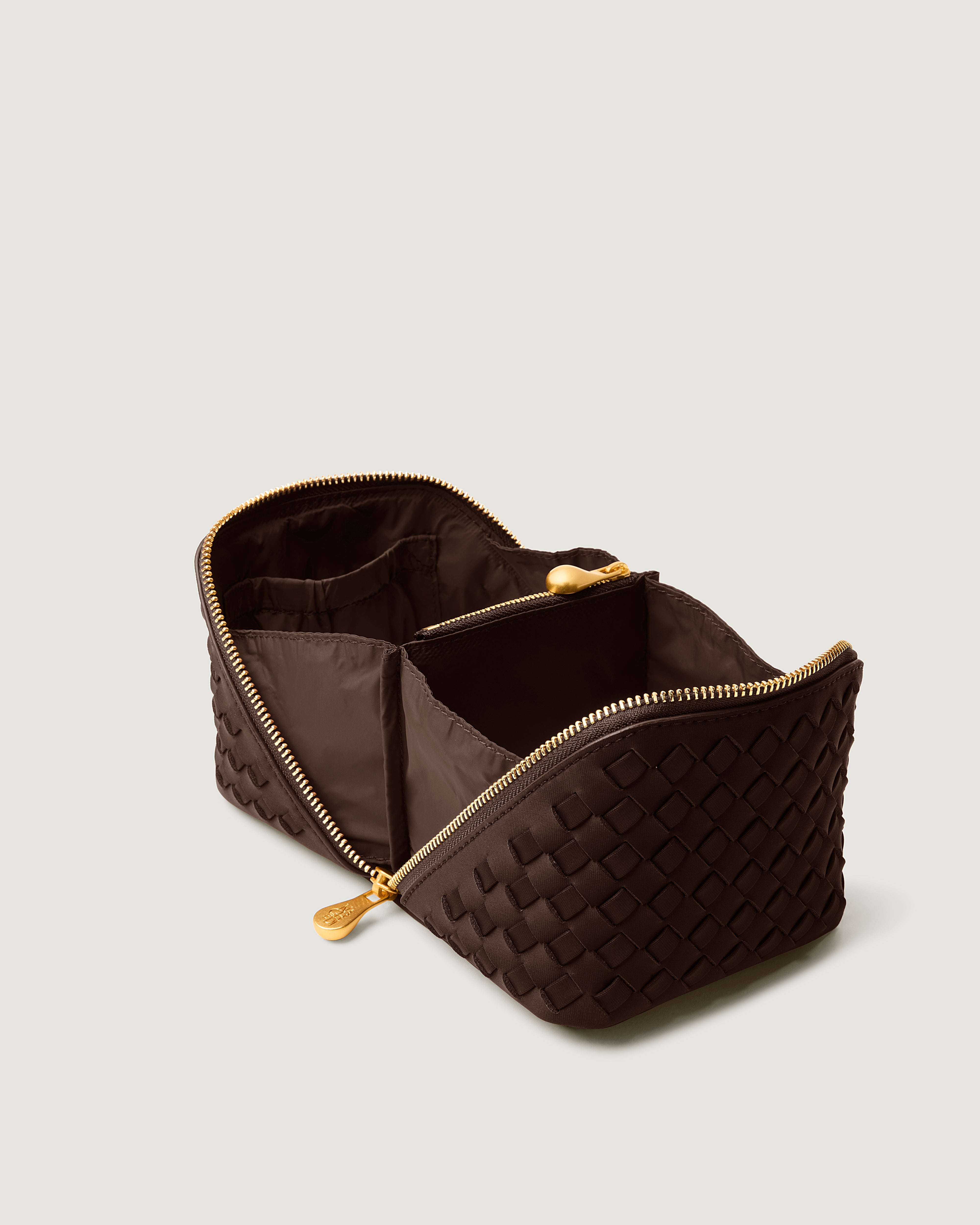 Interior close-up of Caravan Cosmetic Case in Chocolate showing its wrap-around zip closure, and wipe-clean nylon interior.