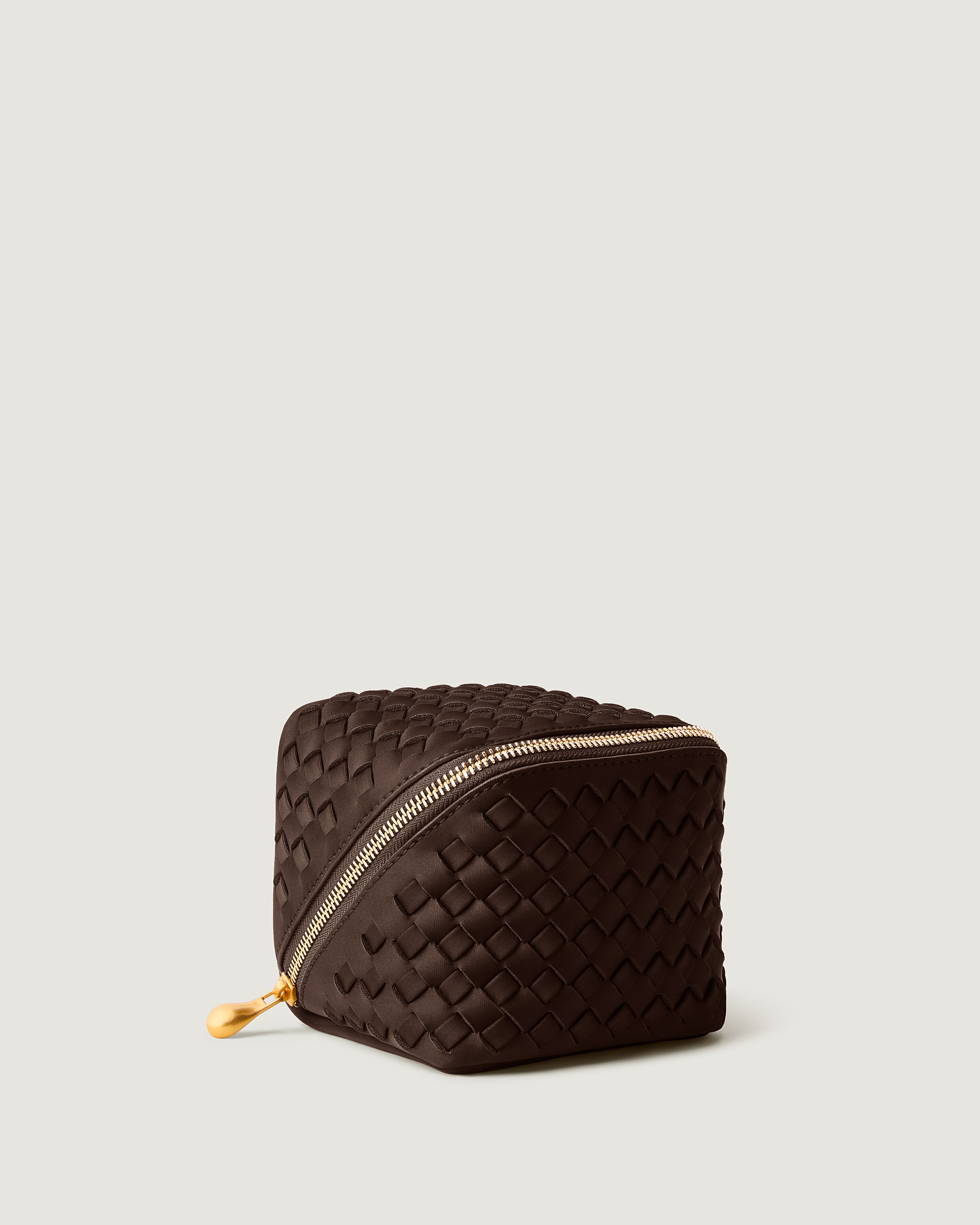 Caravan Cosmetic Case in Chocolate shown from a side angle, highlighting its  and wrap-around zip closure.