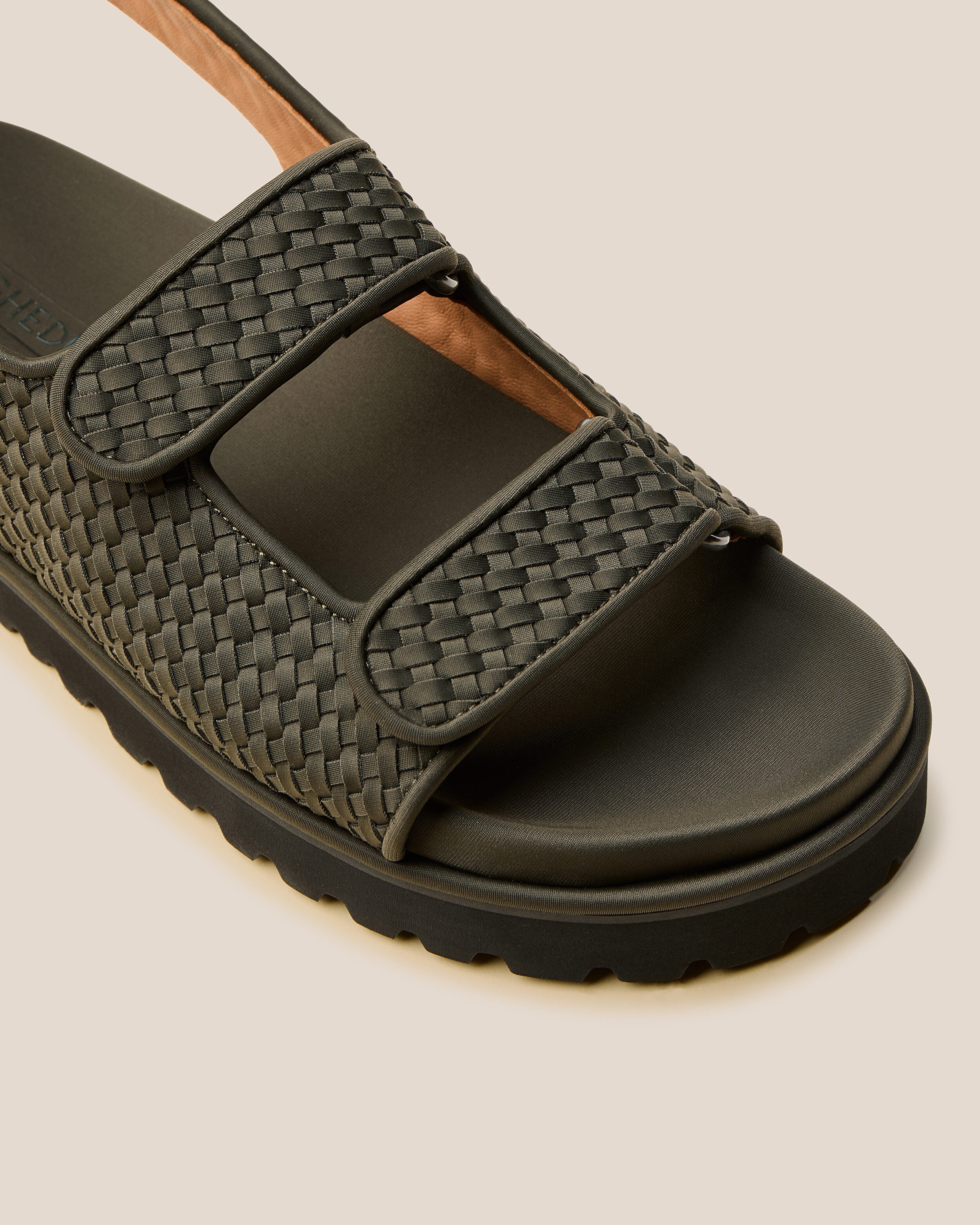 Close-up of The Catalina Sandal in Olive showing its open toe and square silhouette.