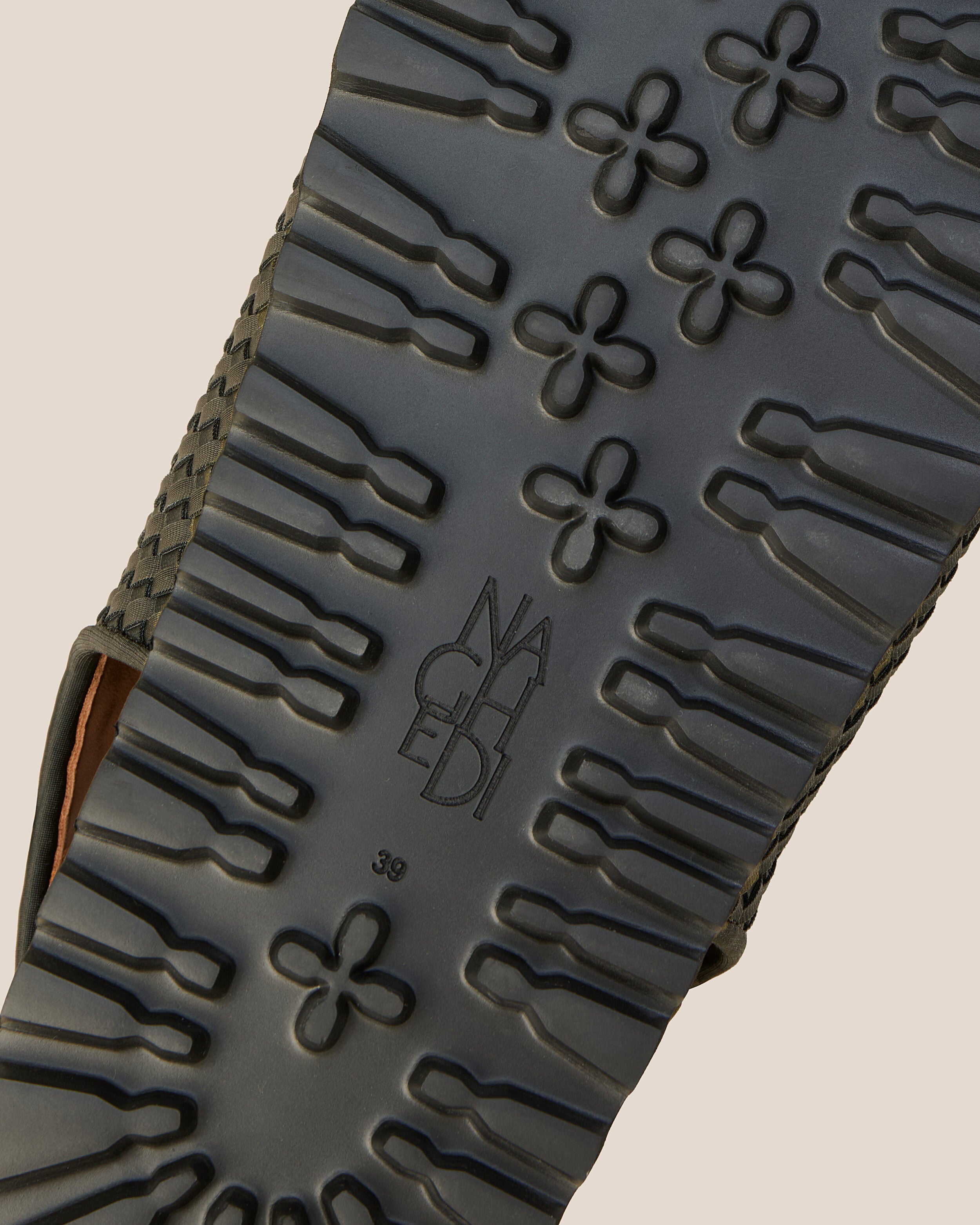 Shoe sole showing extra lightweight eva sole, stamped NAGHEDI logo and size detail for The Catalina Sandal in Olive.