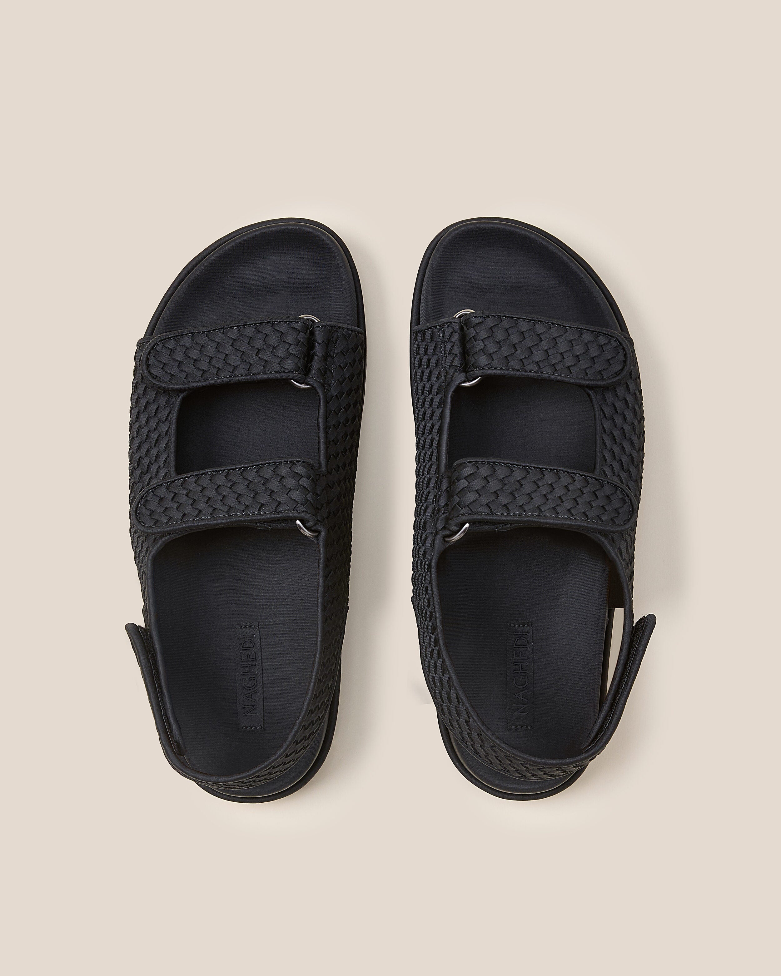 Top view of pair of The Catalina Sandal in Onyx showing the molded neoprene footbed.