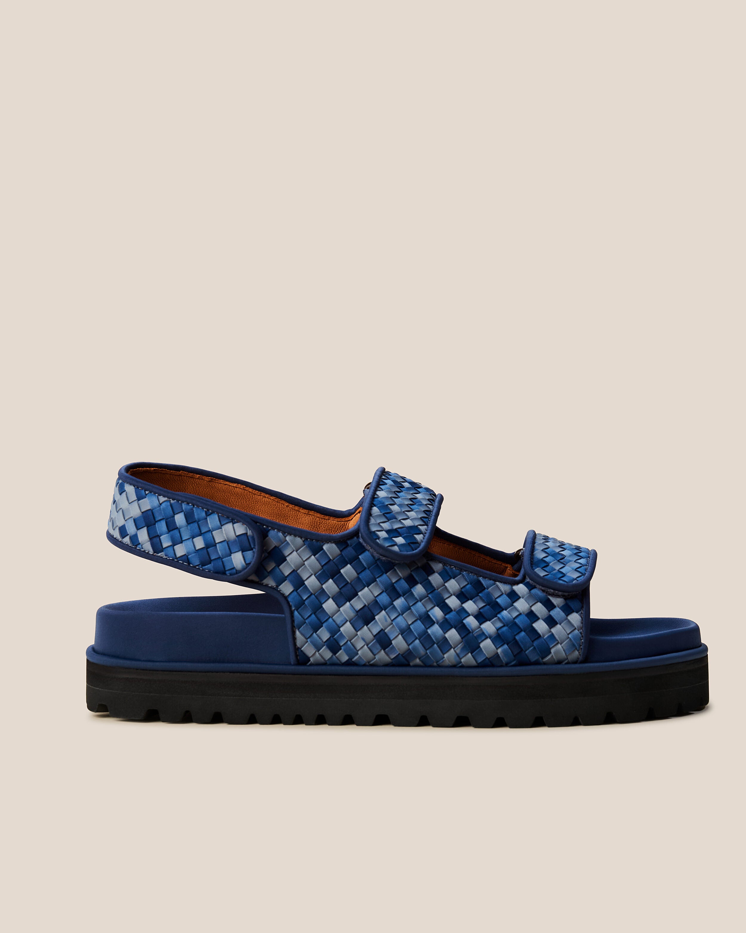 Side view of The Catalina Sandal in Paros, a denim blue and navy tone, featuring an open toe and square silhouette, featuring a 3-strap sandal.