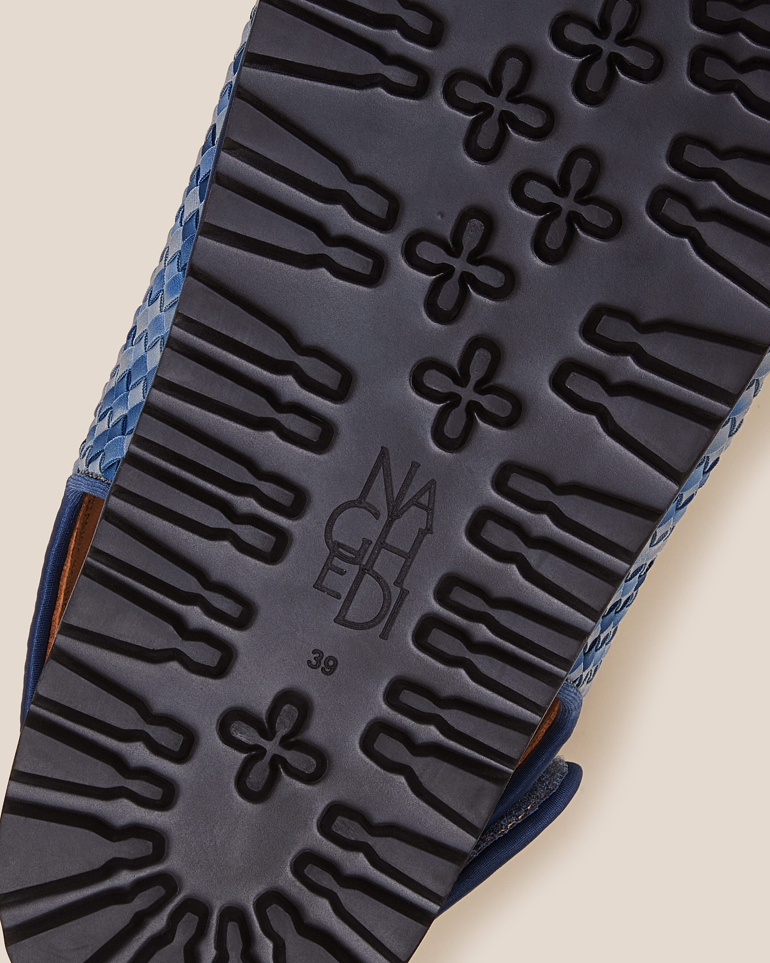 Shoe sole showing extra lightweight eva sole, stamped NAGHEDI logo and size detail for The Catalina Sandal in Paros.