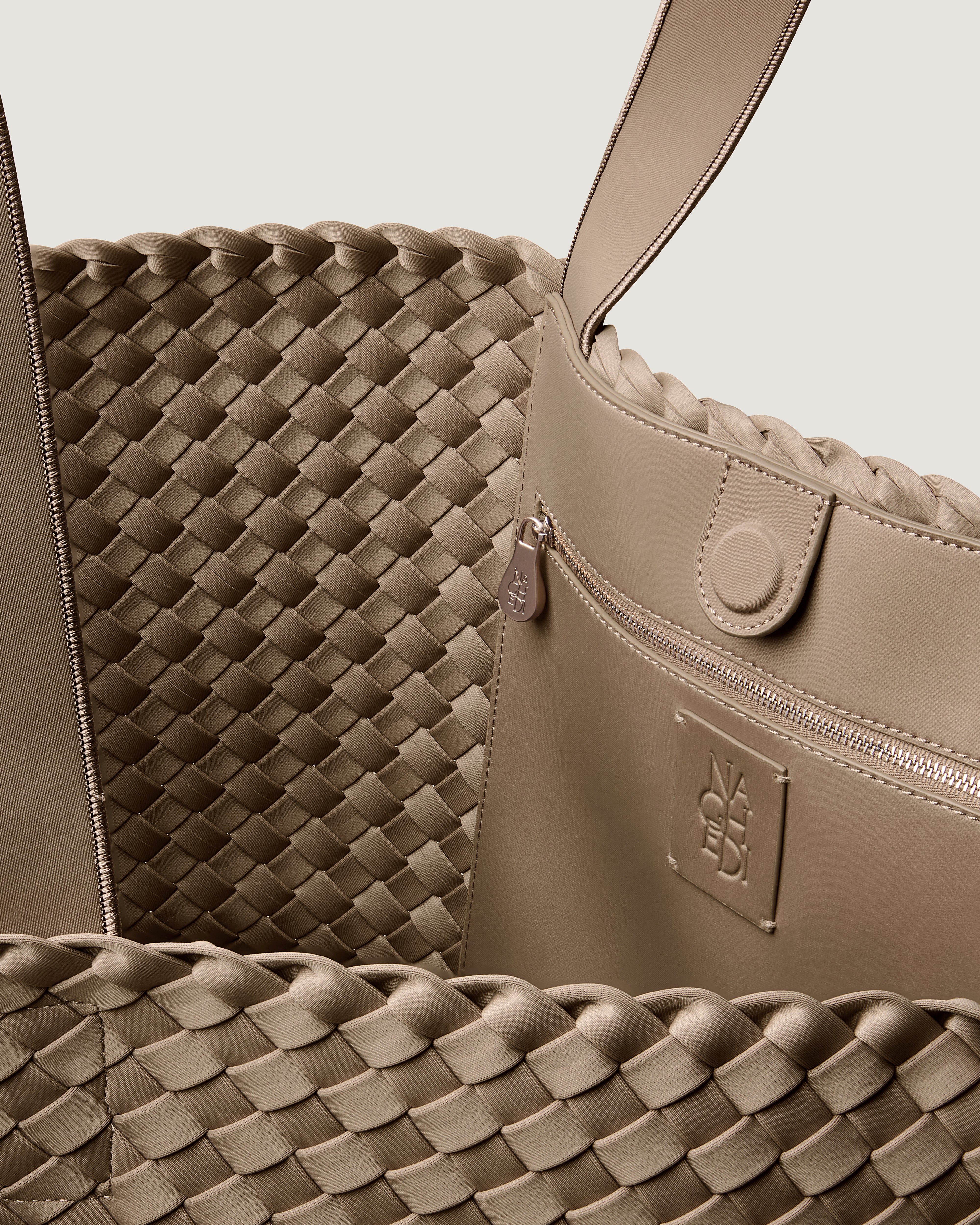 Interior close-up of Como Tote in Cashmere showing its open top with magnetic snap closure, interior zip pocket, and unlined interior.