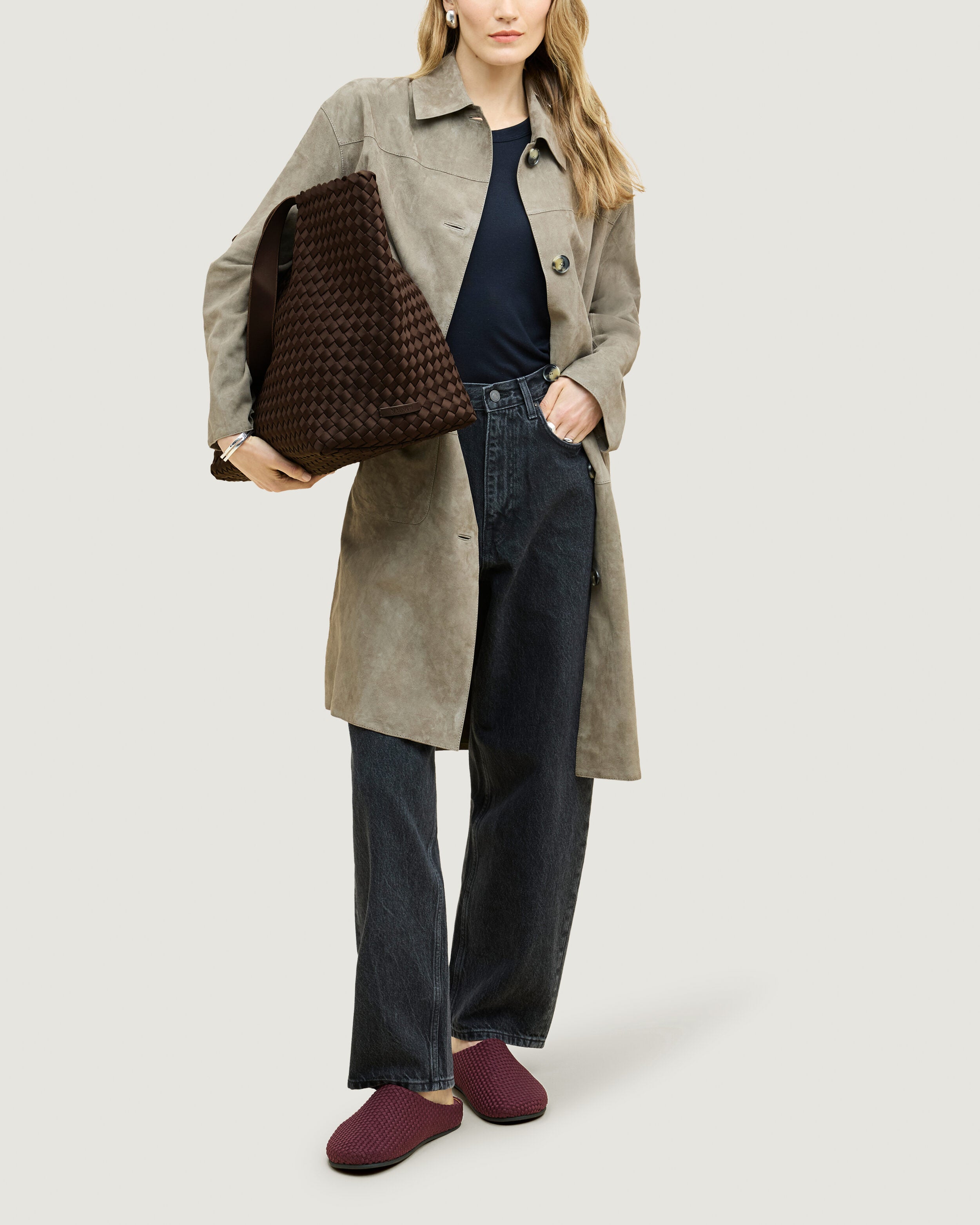 Como Tote in Chocolate shown on model to illustrate scale and soft silhouette.