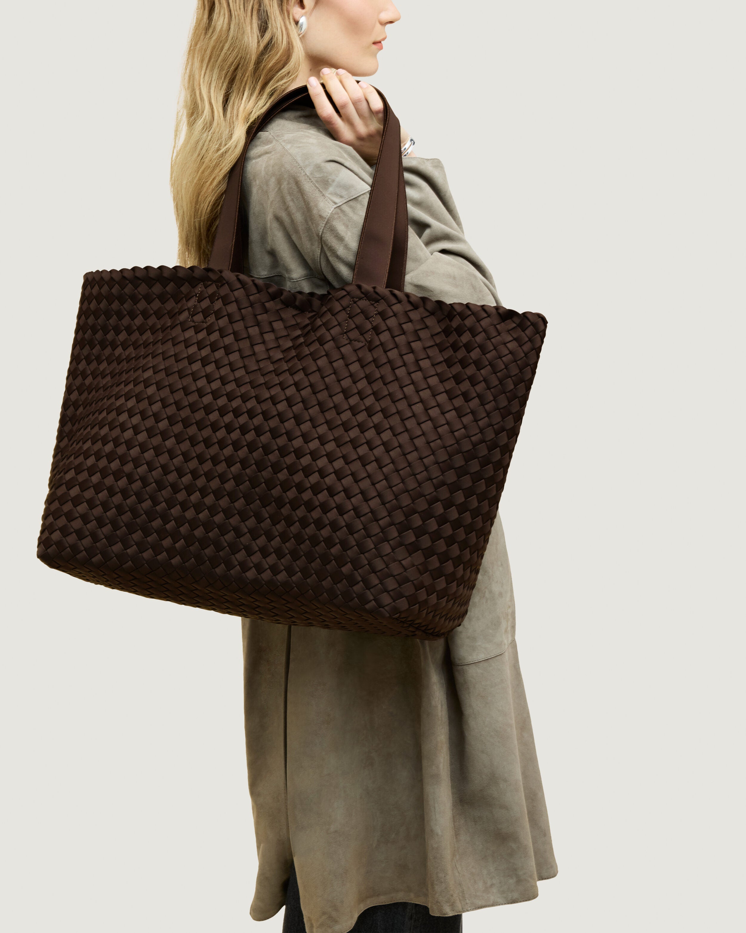 Como Tote in Chocolate shown on model to illustrate scale and soft silhouette.