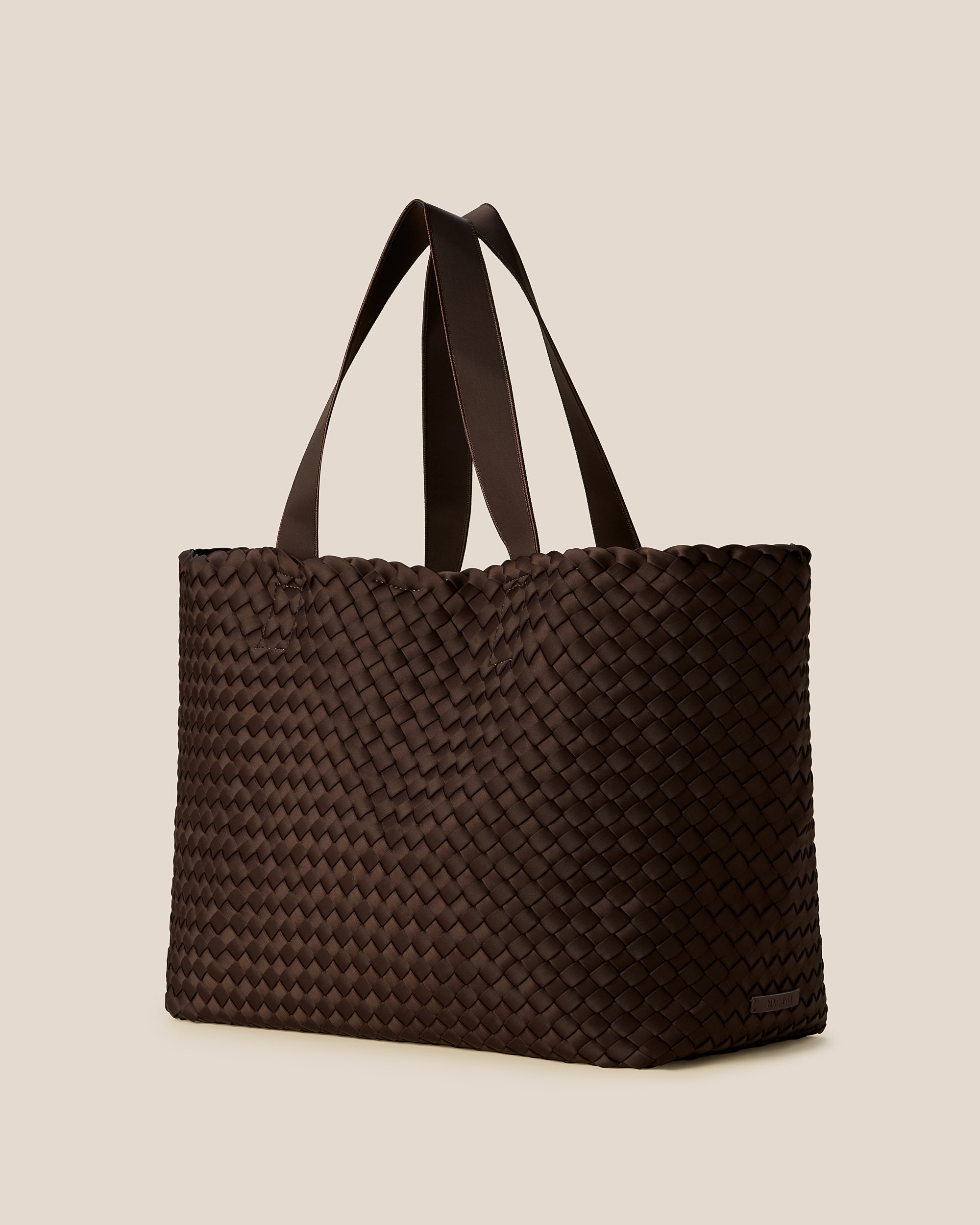 Como Large Tote Bag in Chocolate shown from a side angle, highlighting its handwoven neoprene and open top with magnetic snap closure.