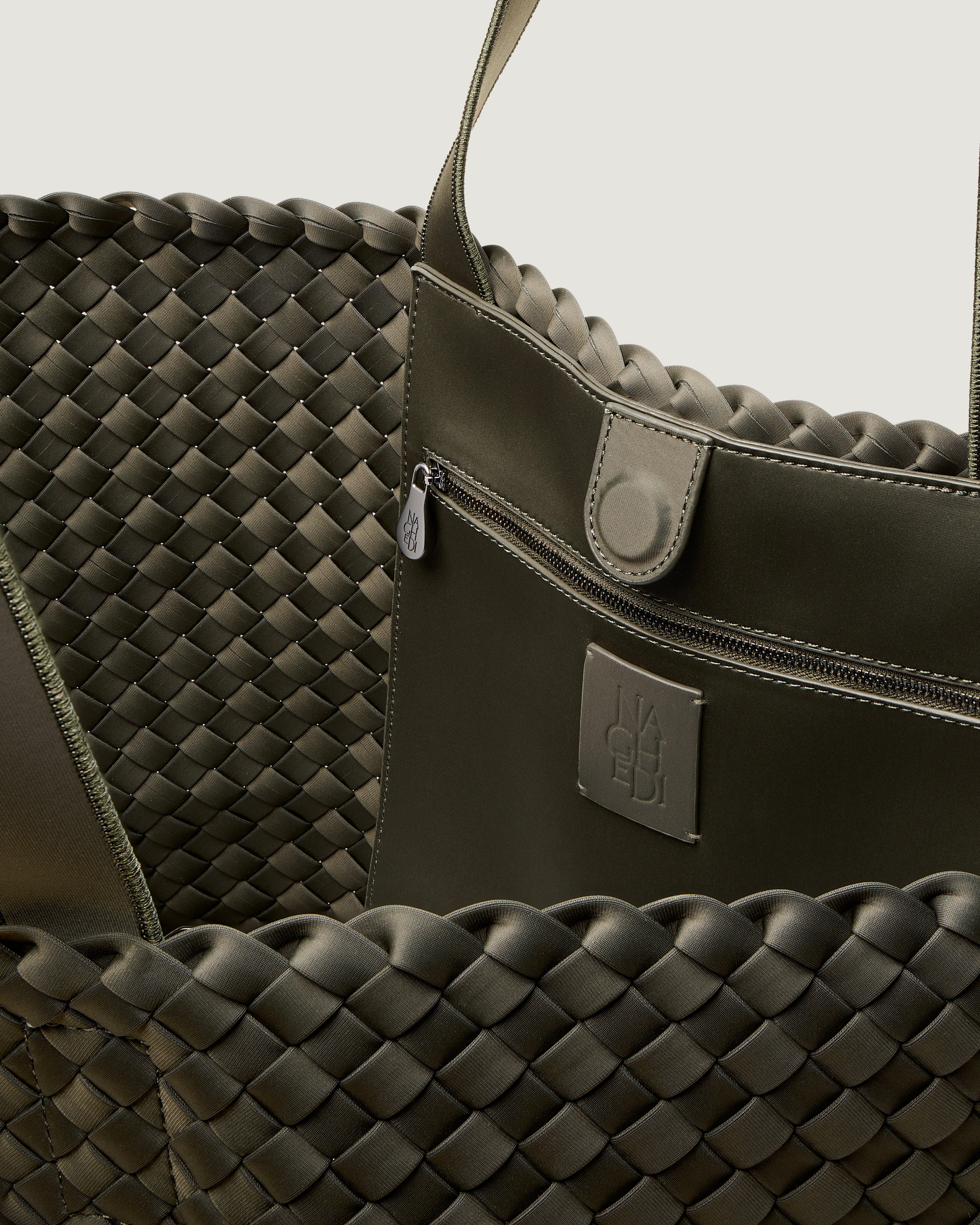 Interior close-up of Como Tote in Olive showing its open top with magnetic snap closure, interior zip pocket, and unlined interior.