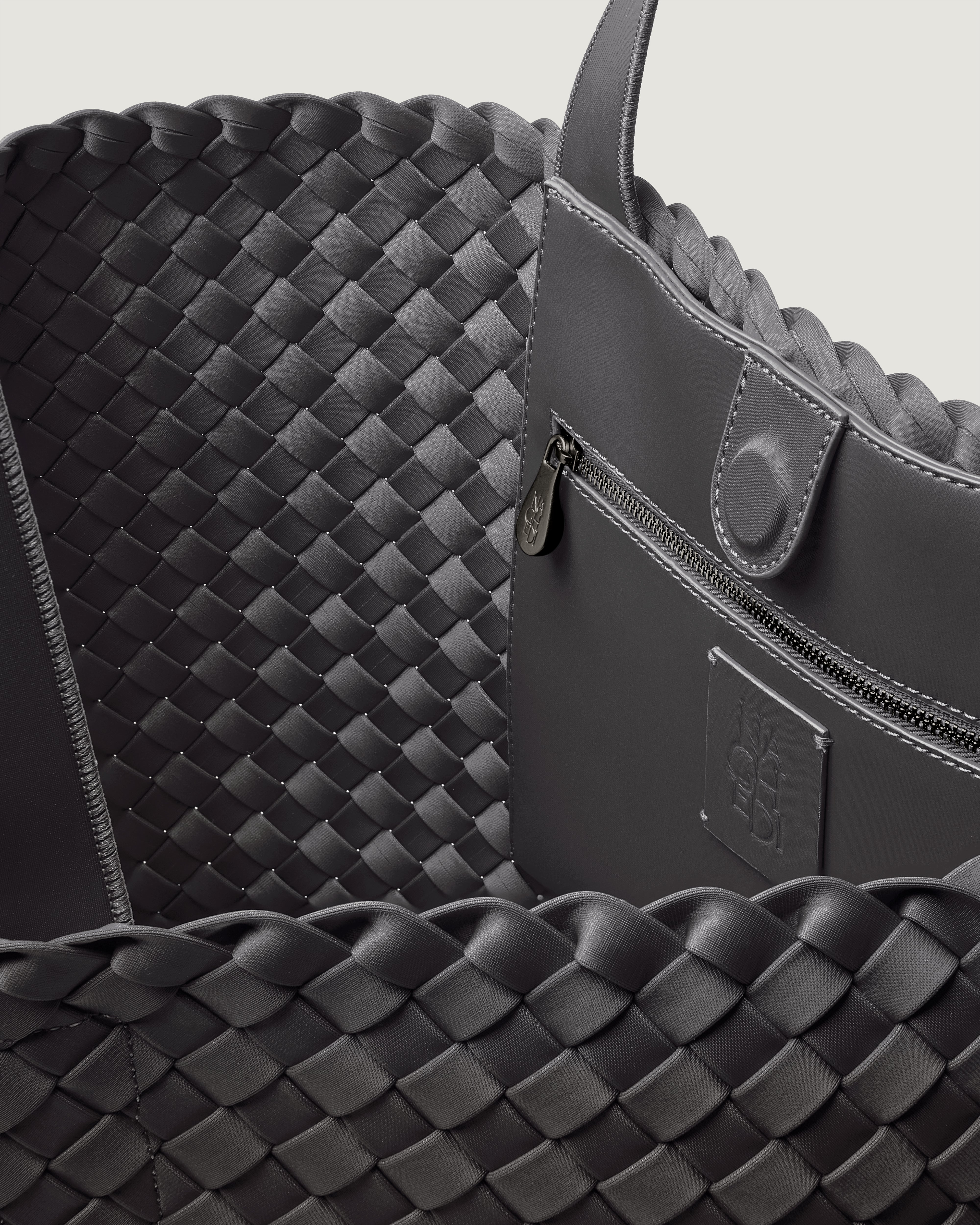 Interior close-up of Como Tote in Ash showing its open top with magnetic snap closure, interior zip pocket, and unlined interior.