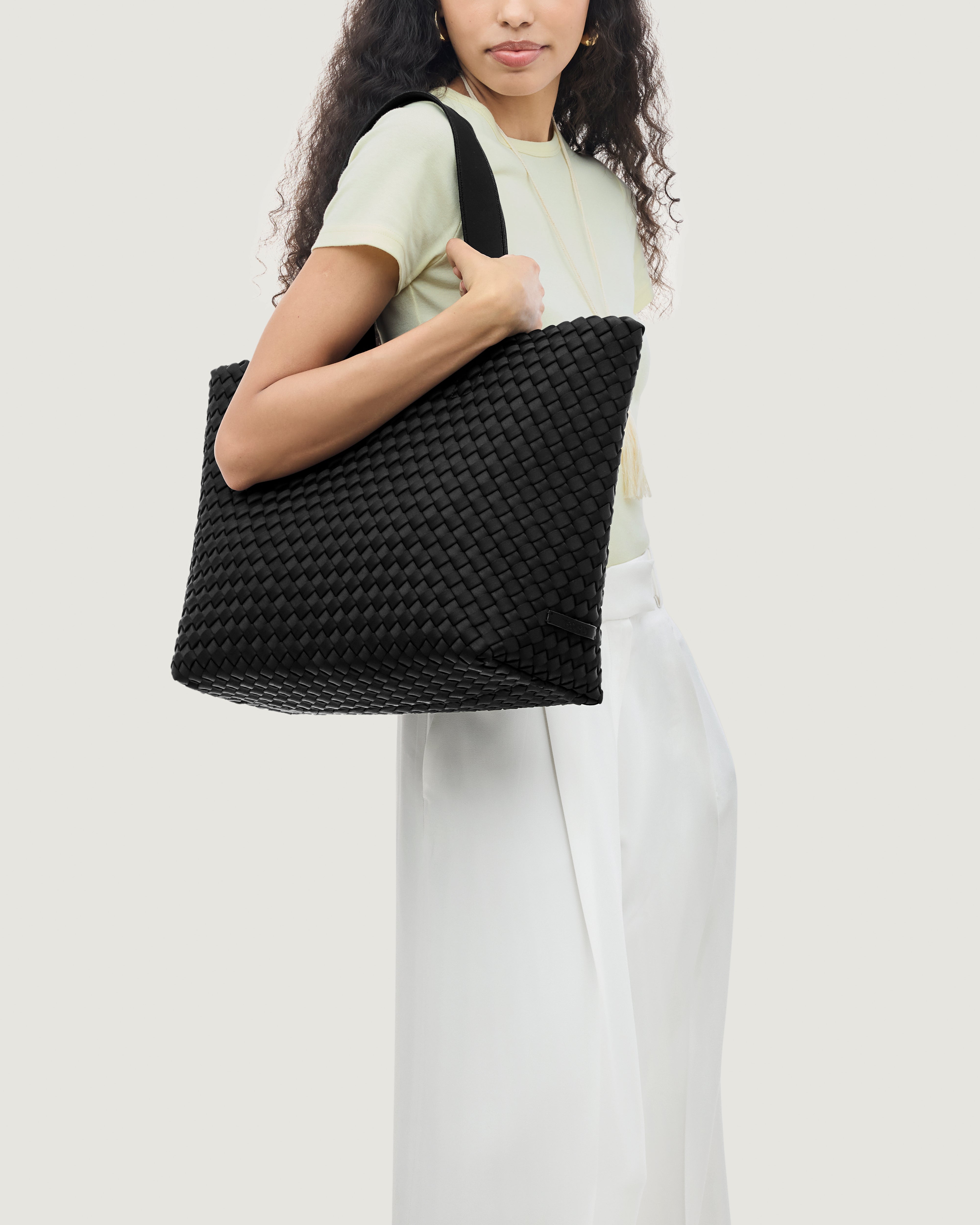 Como Tote in Onyx shown on model to illustrate scale and soft silhouette.