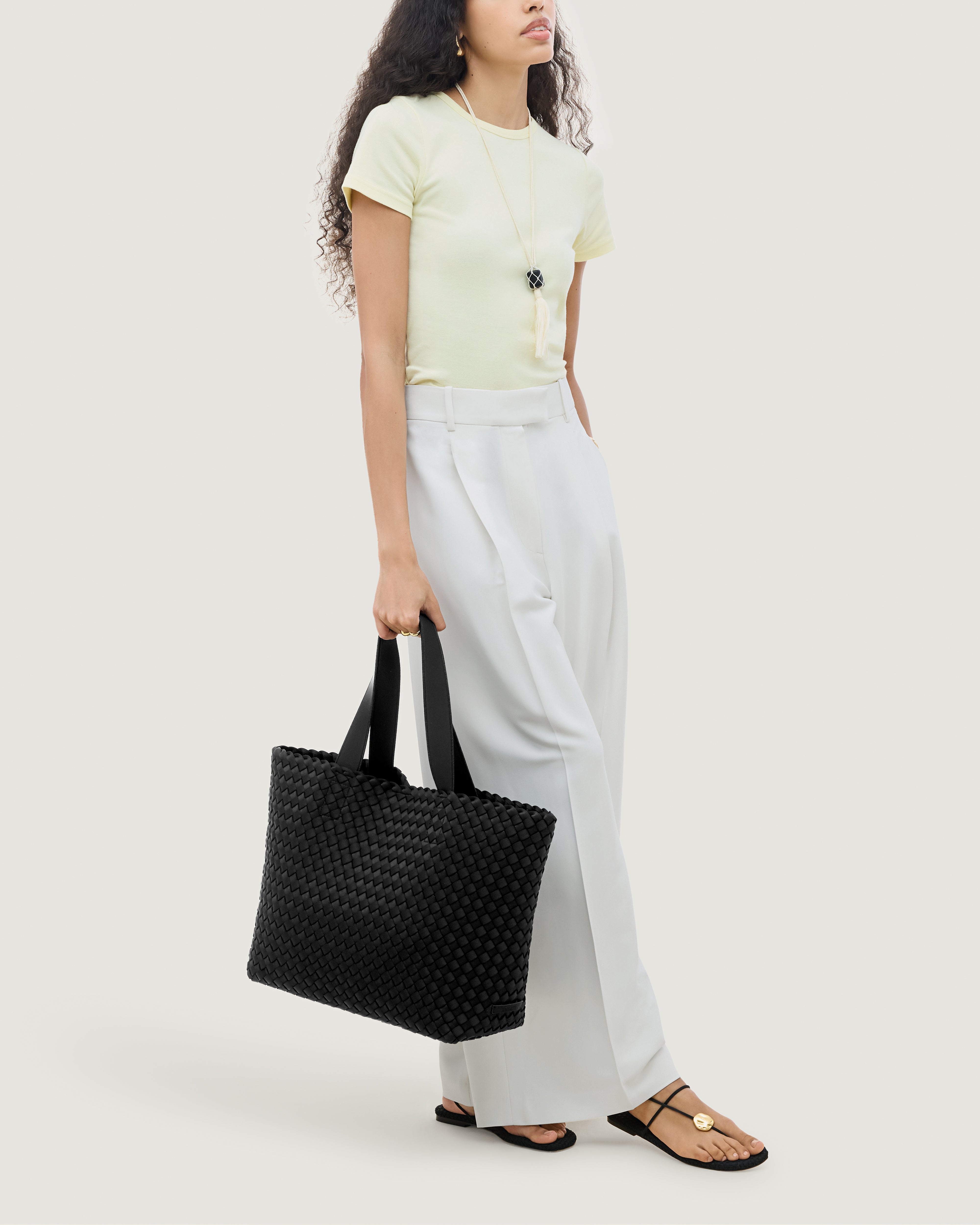 Como Tote in Onyx shown on model to illustrate scale and soft silhouette.