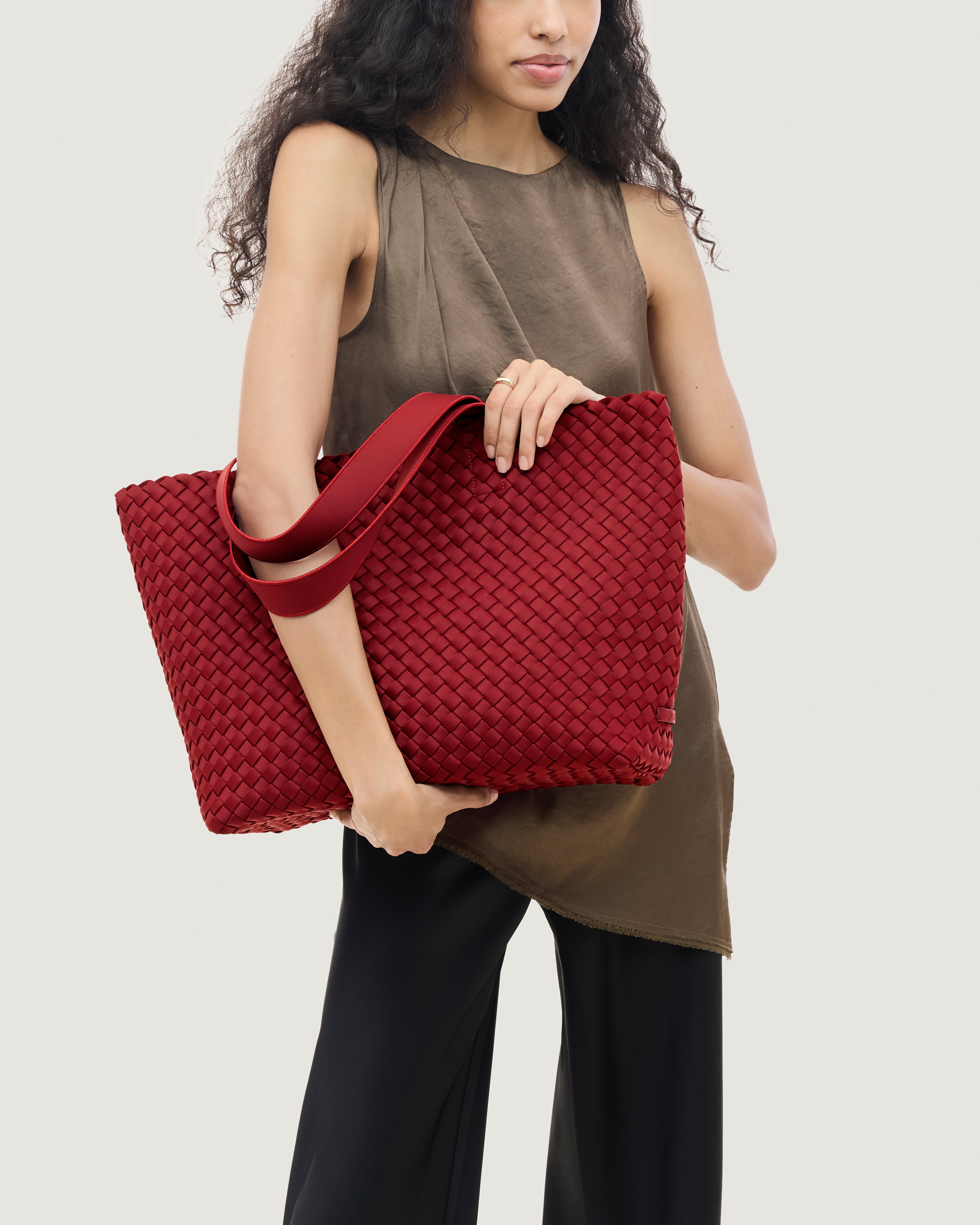 Como Tote in Rosso shown on model to illustrate scale and soft silhouette.