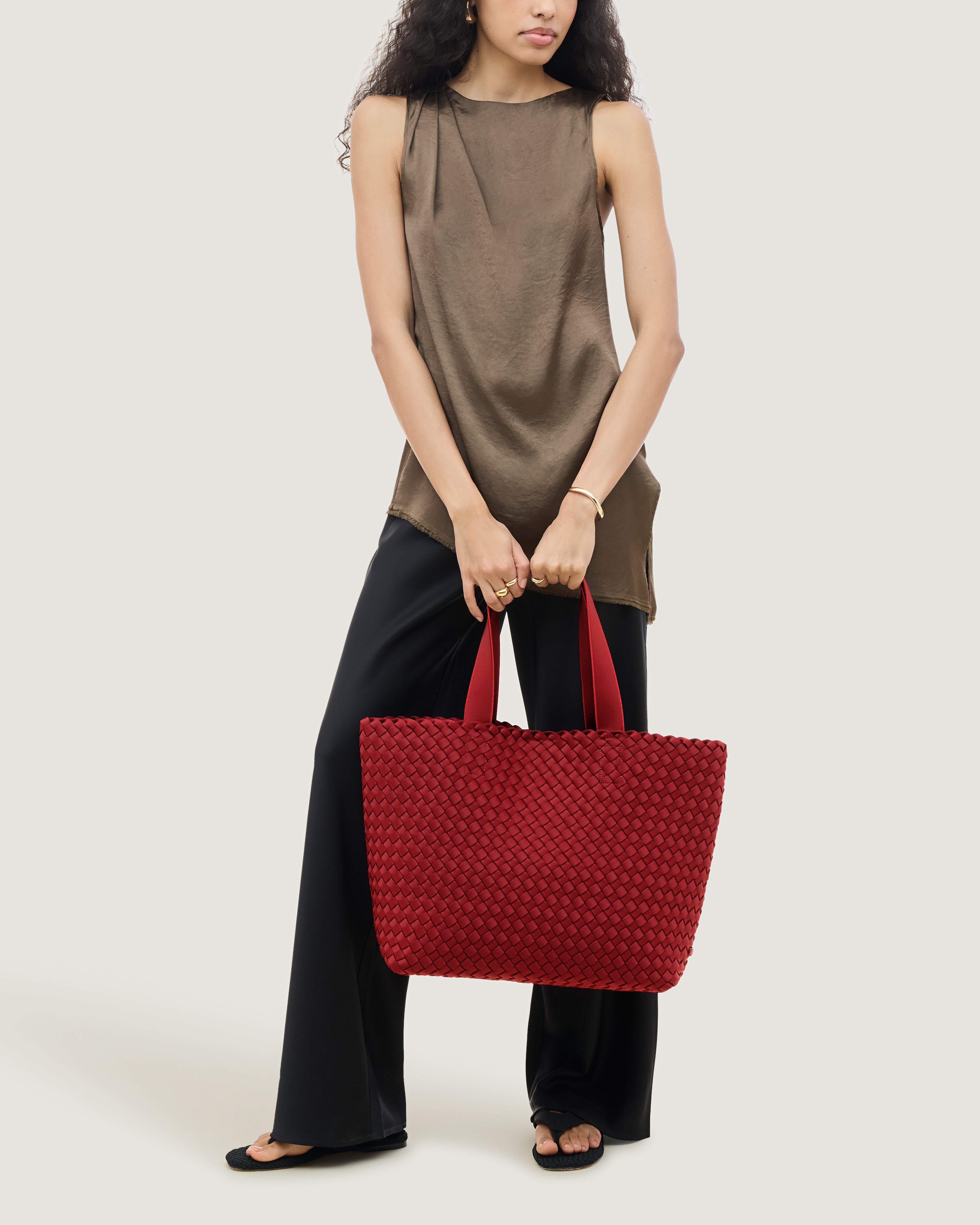 Como Tote in Rosso shown on model to illustrate scale and soft silhouette.