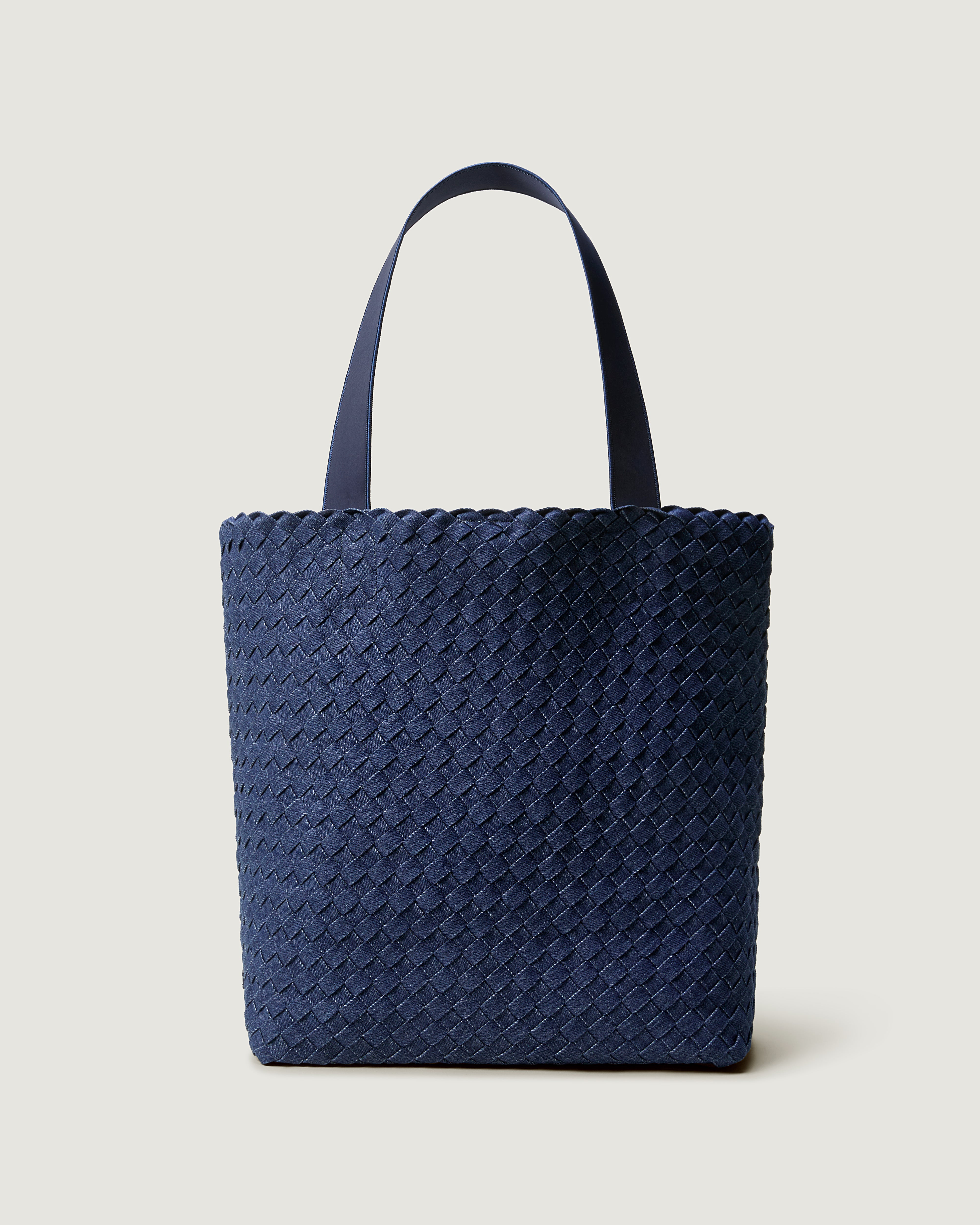 Como Tote in handwoven Denim, featuring an open top with magnetic snap closure, and neoprene shoulder straps.