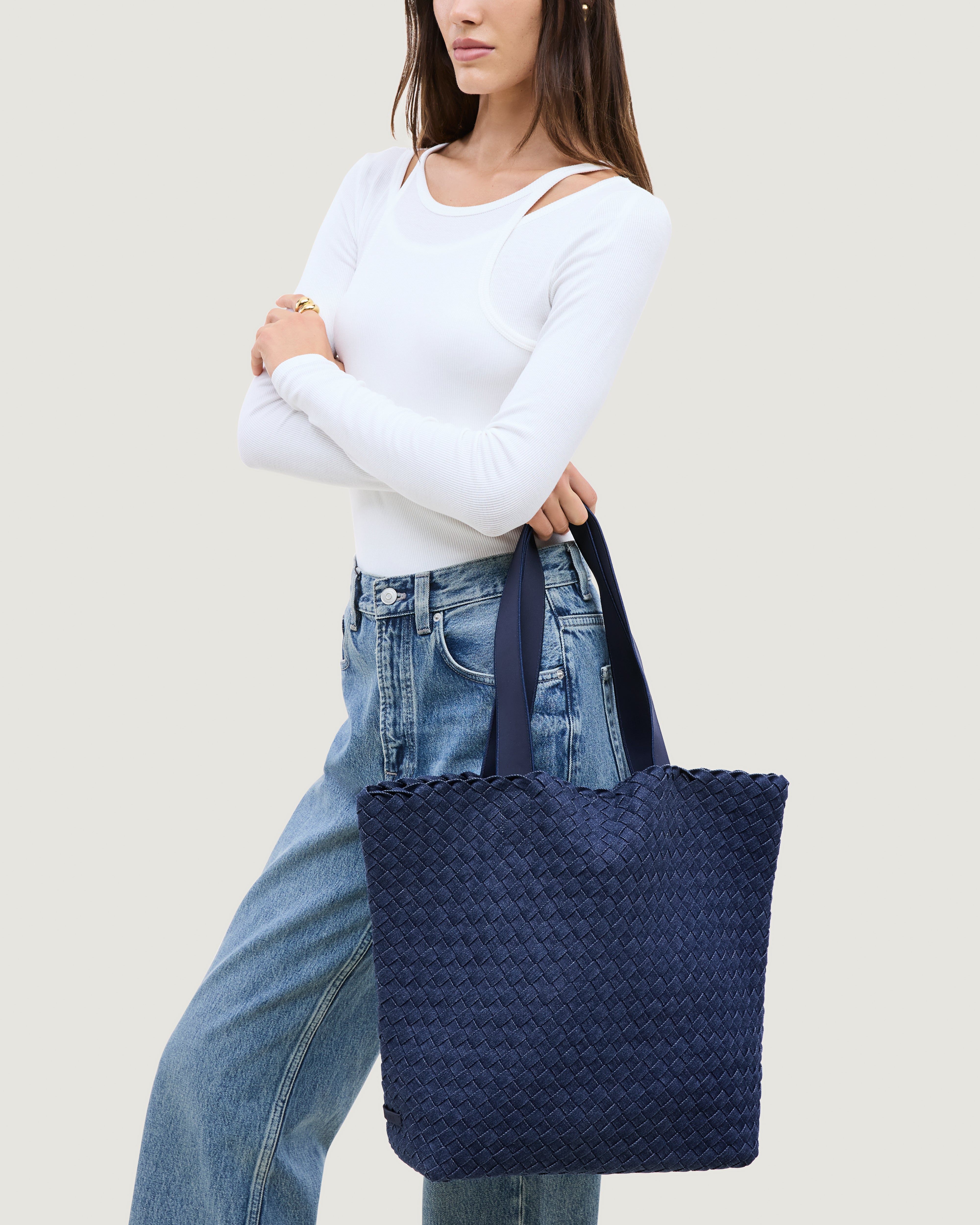 Como Tote in Denim shown on model to illustrate scale and soft silhouette.