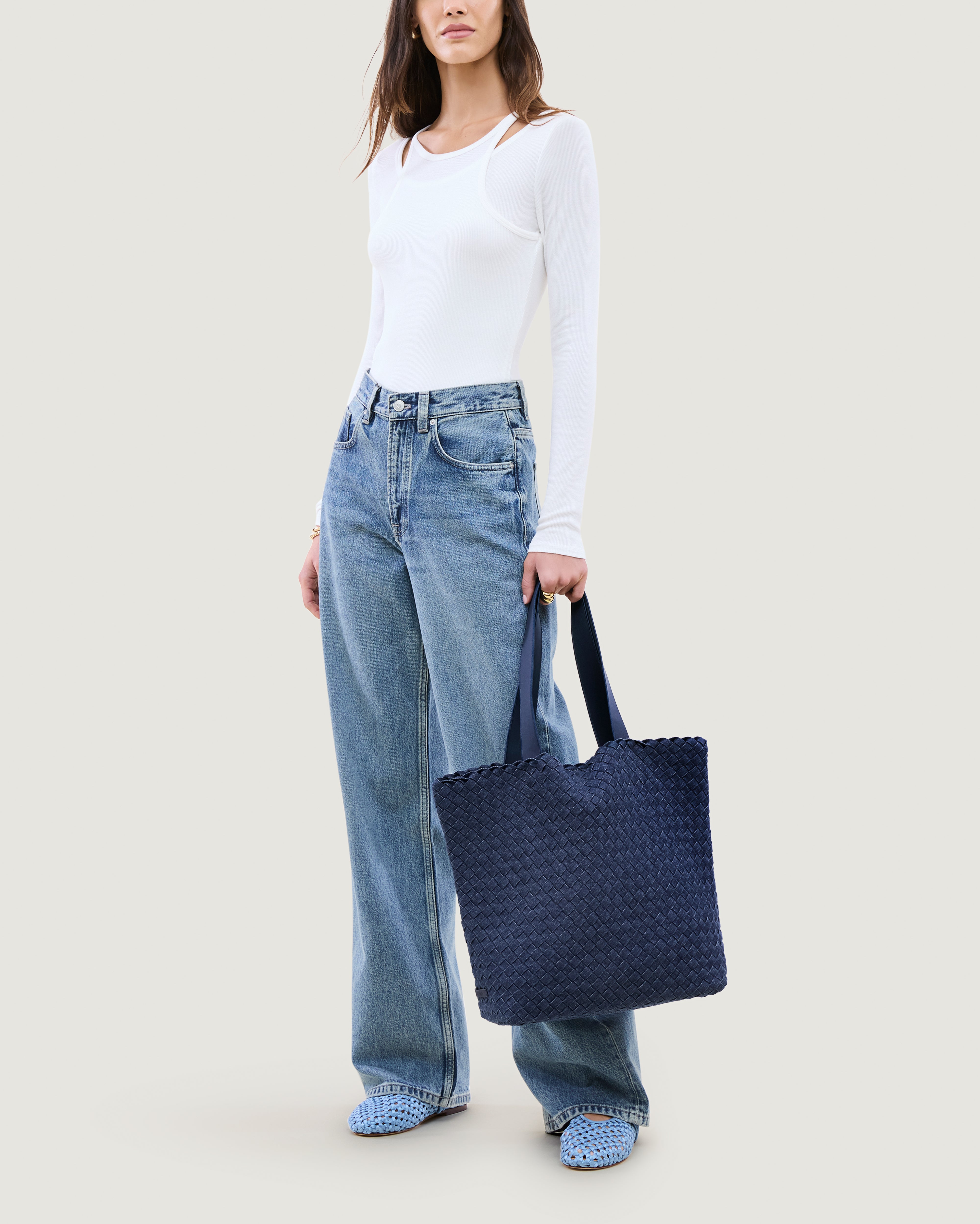 Como Tote in Denim shown on model to illustrate scale and soft silhouette.