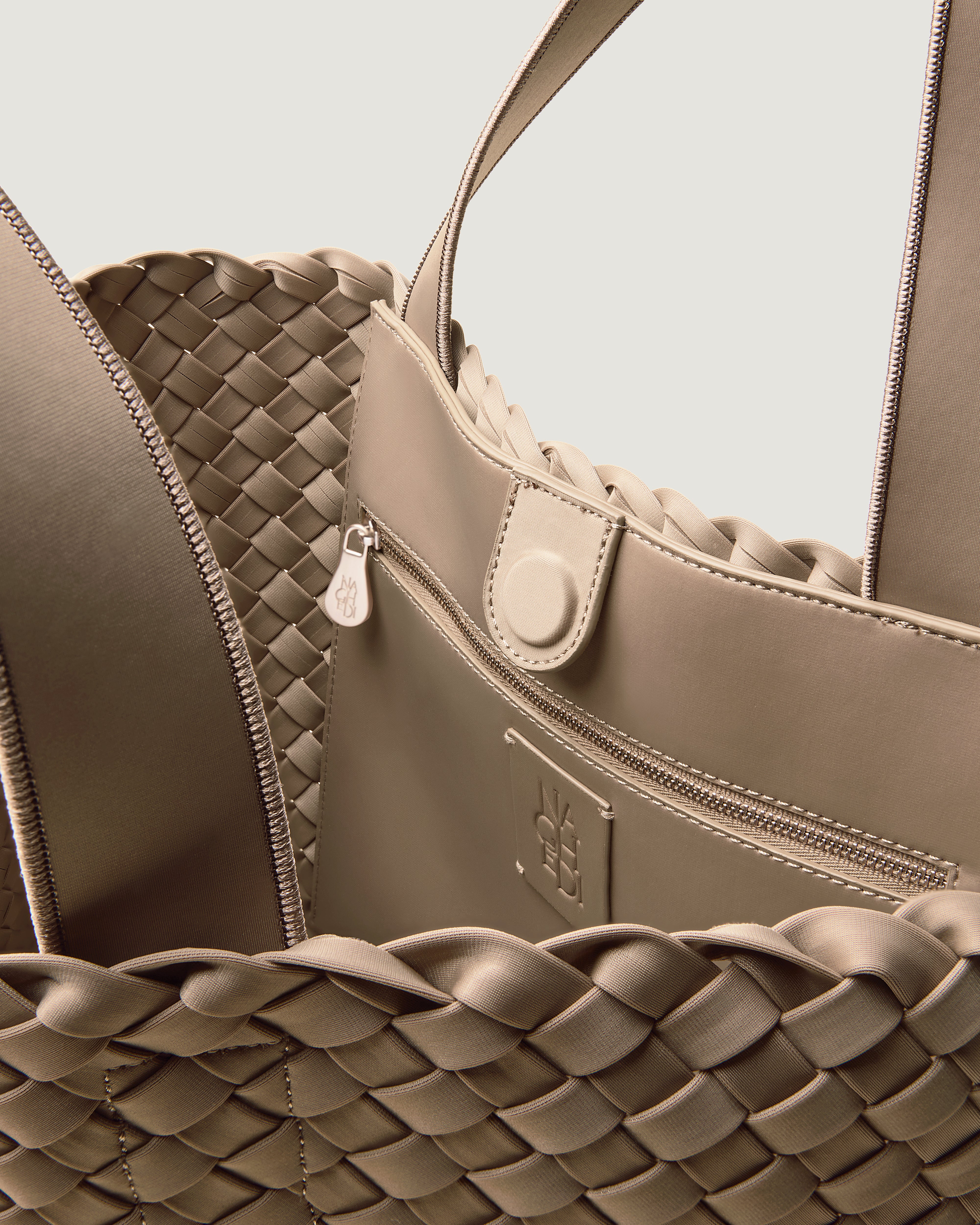 Interior close-up of Como Tote in Cashmere showing its open top with magnetic snap closure, interior zip pocket, and unlined interior.