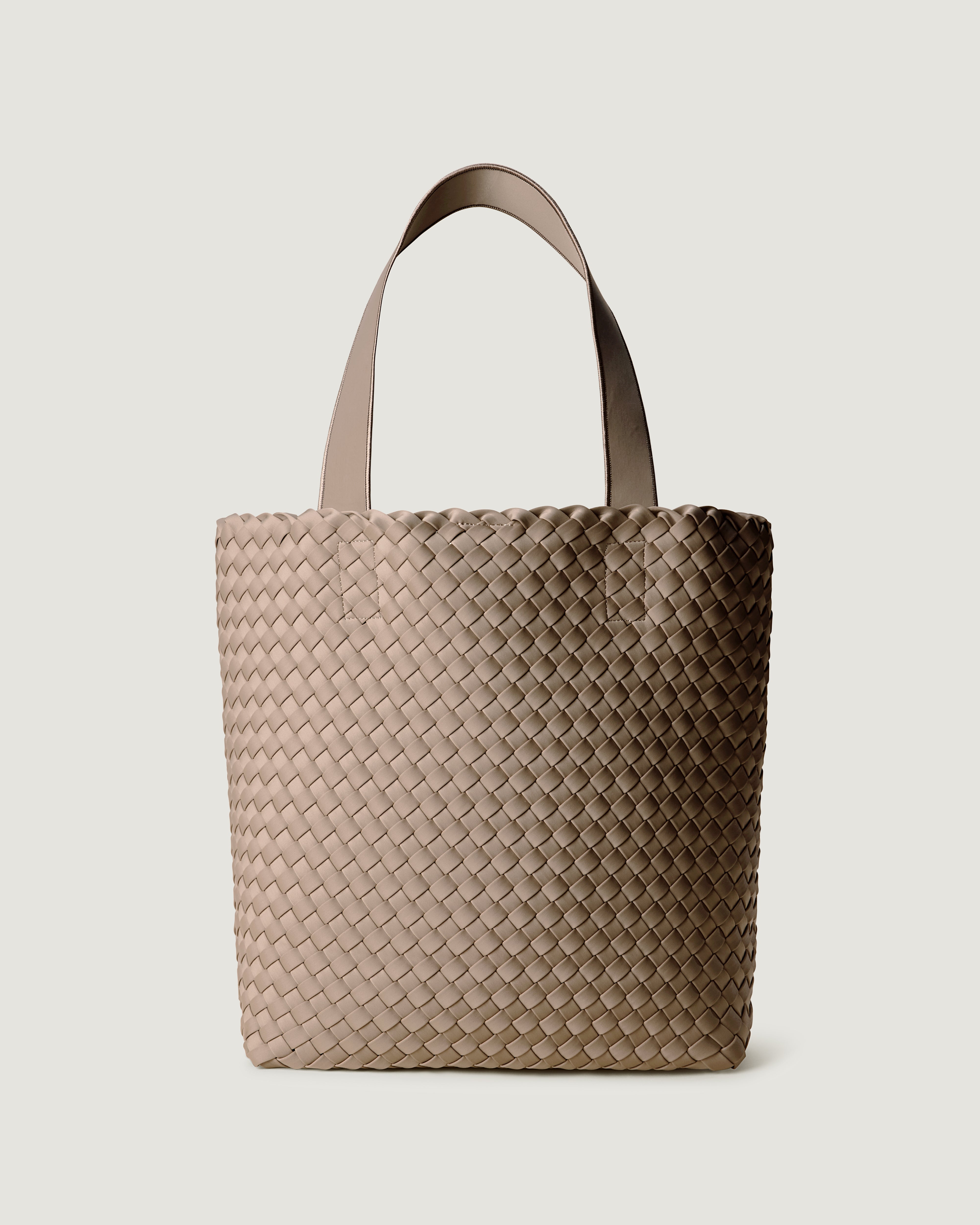 Como Tote in Cashmere, a taupe tone, in handwoven neoprene, featuring an open top with magnetic snap closure, and neoprene shoulder straps.